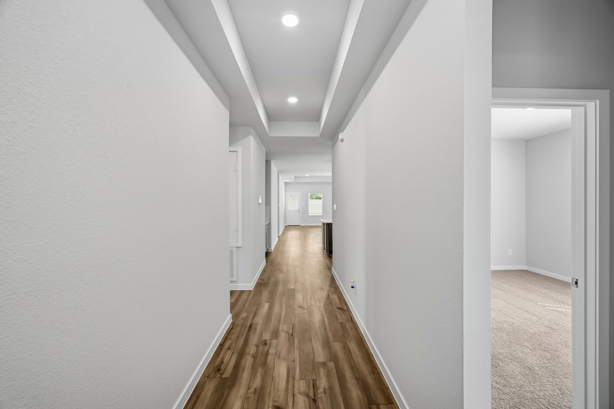 A long hallway with white walls.