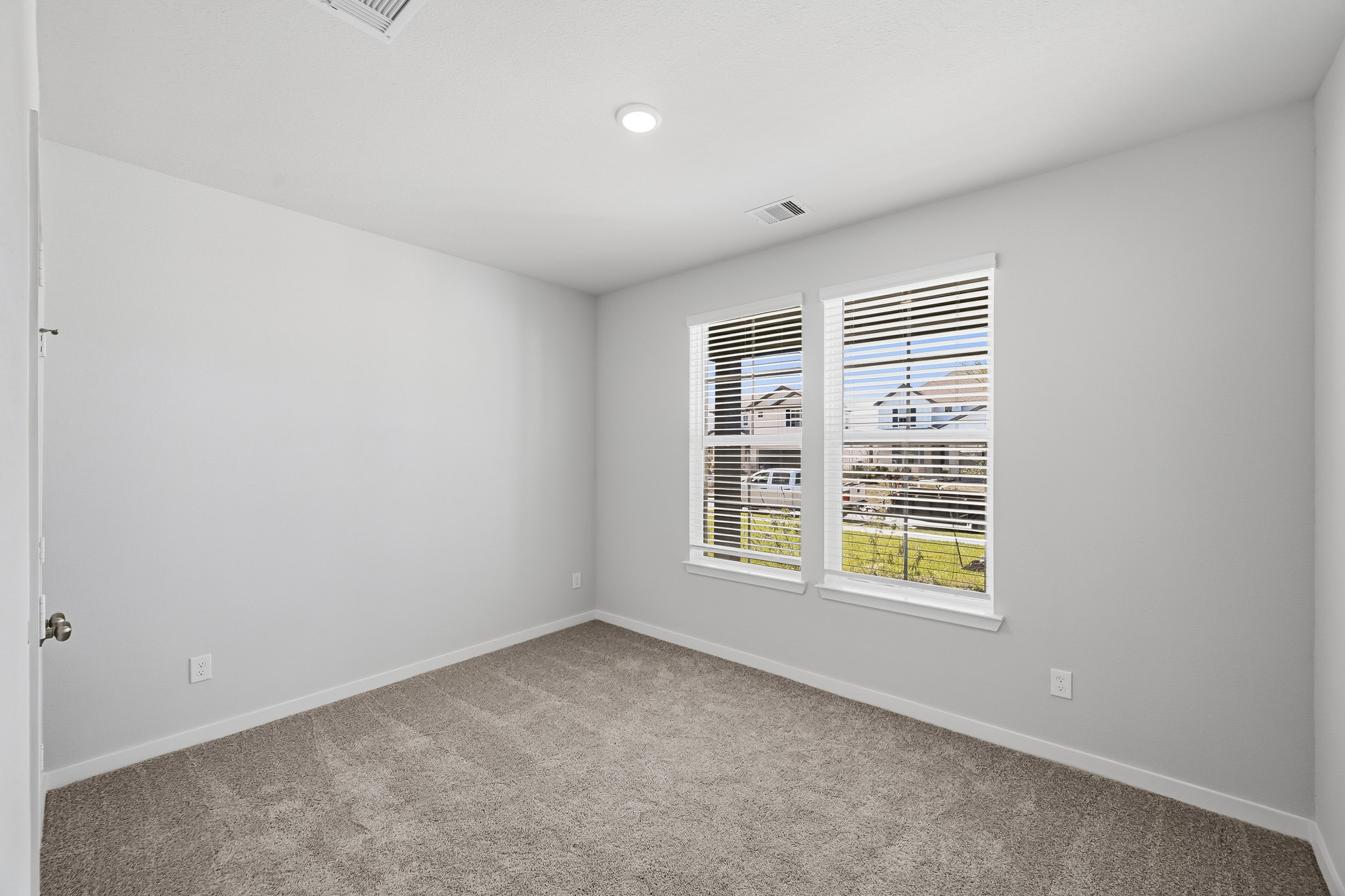 A room with a window and a carpet.
