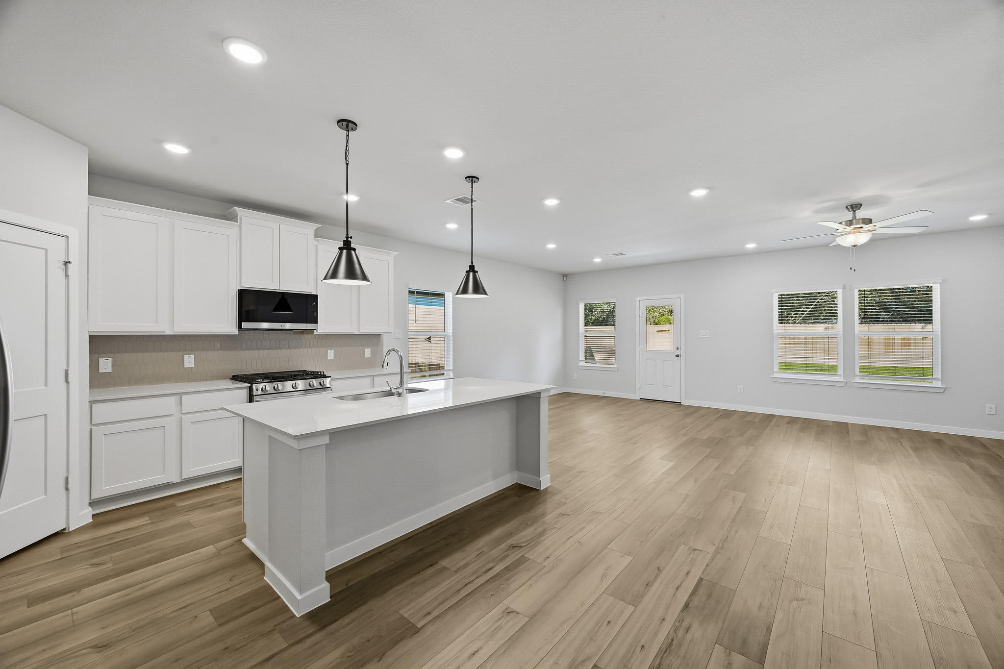 A kitchen with white cabinets.