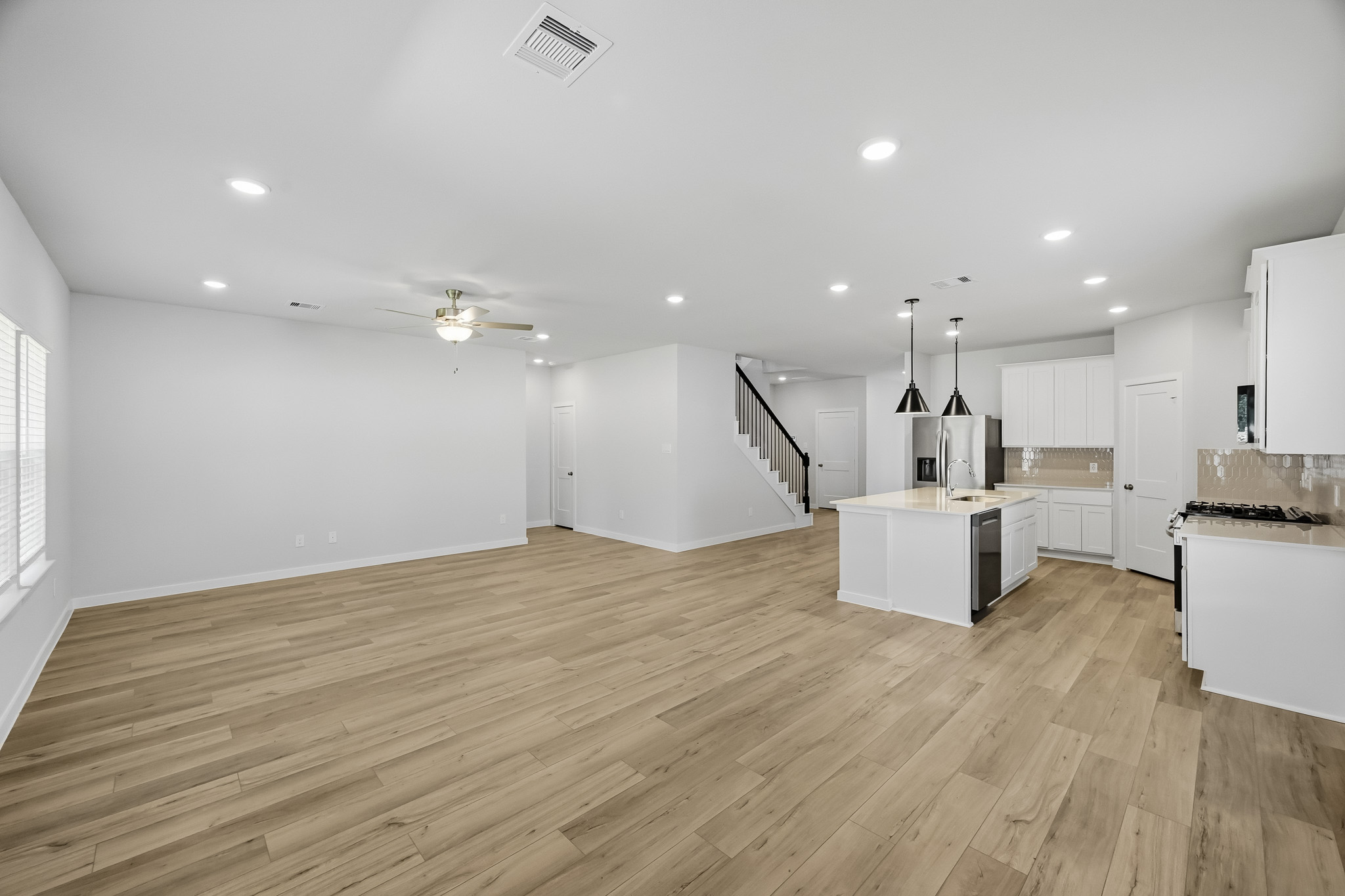 A large kitchen with white cabinets.