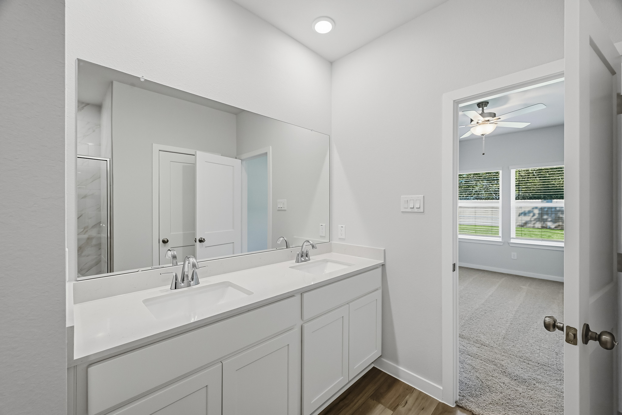 A bathroom with a large mirror.