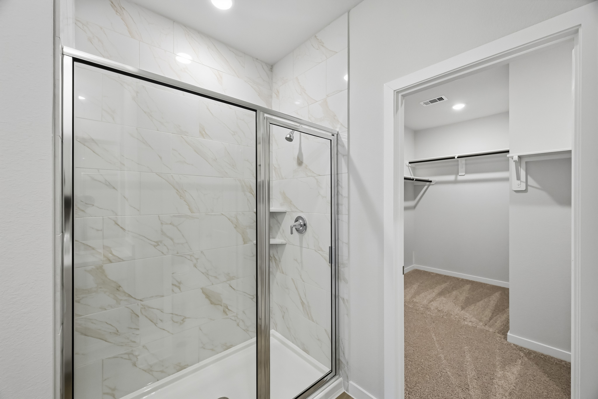 A shower with a glass door.