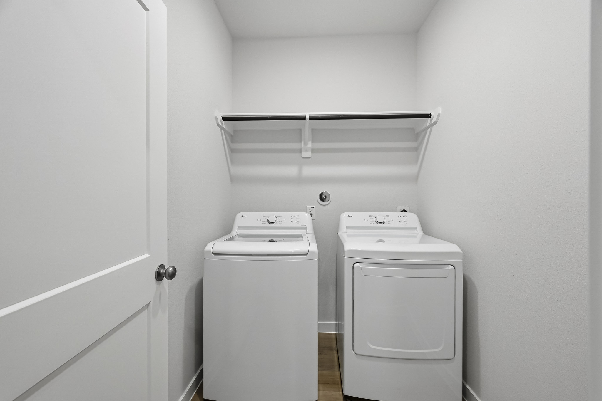 A white room with a washer and dryer.