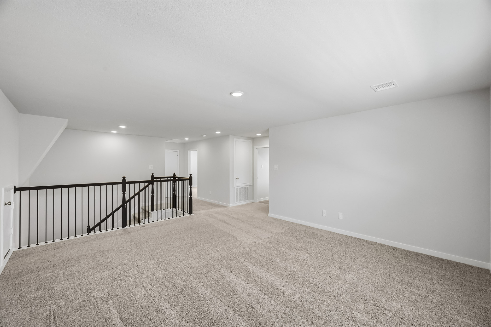 A long hallway with white walls.