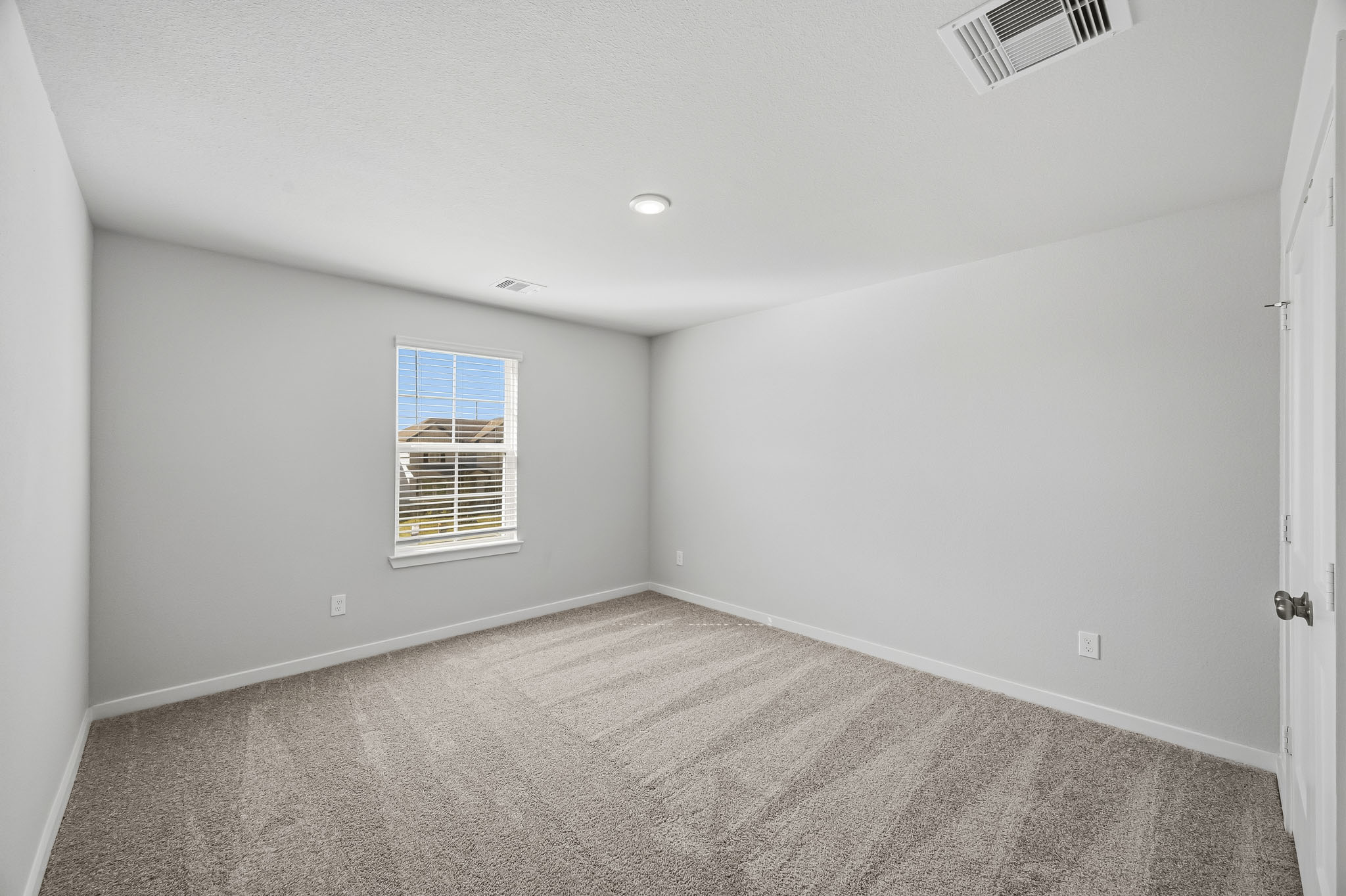 A room with a window and a door.