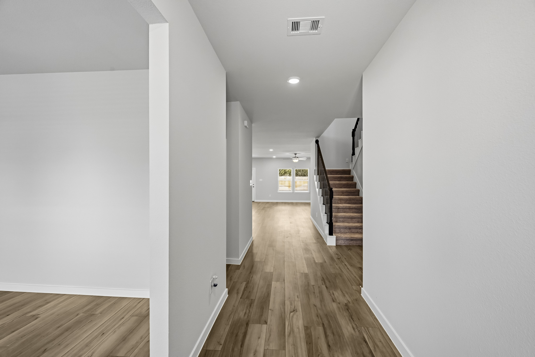 A hallway with white walls.