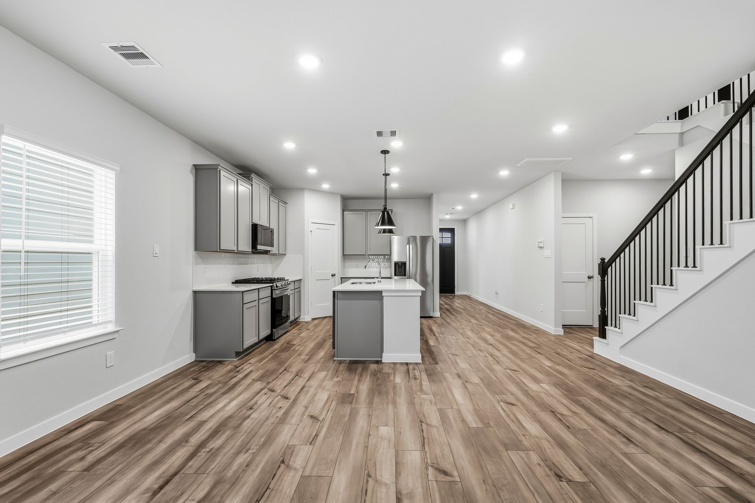 A large kitchen with white cabinets.
