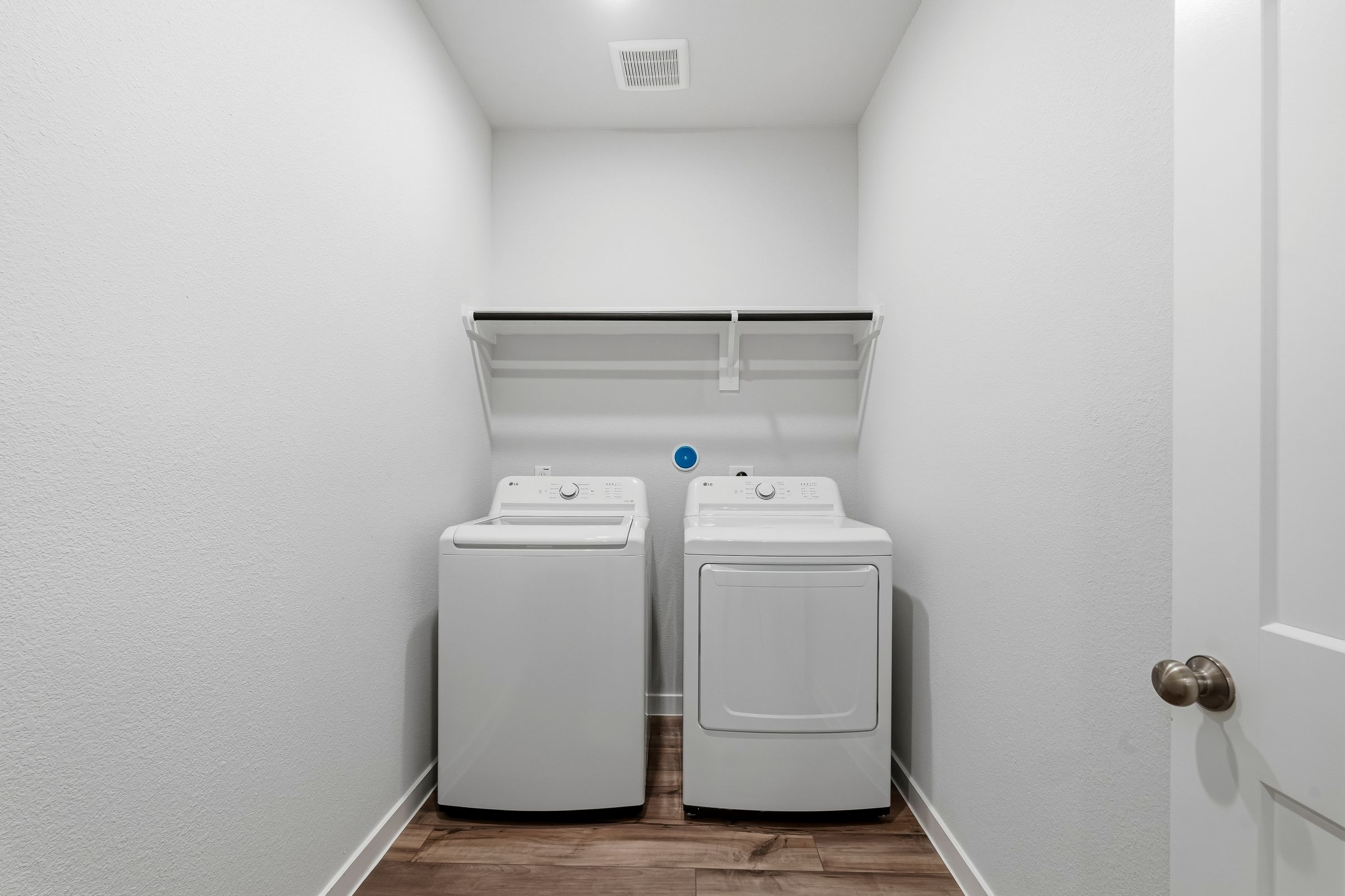 A white room with a white wall and a white door.