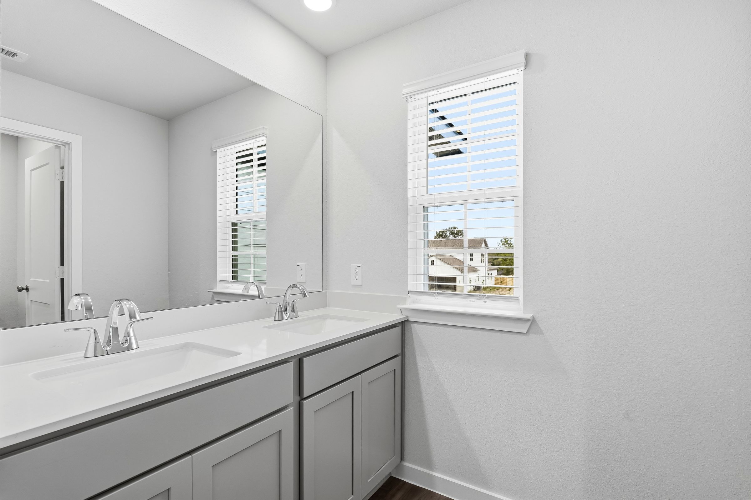 A bathroom with a sink and a window.