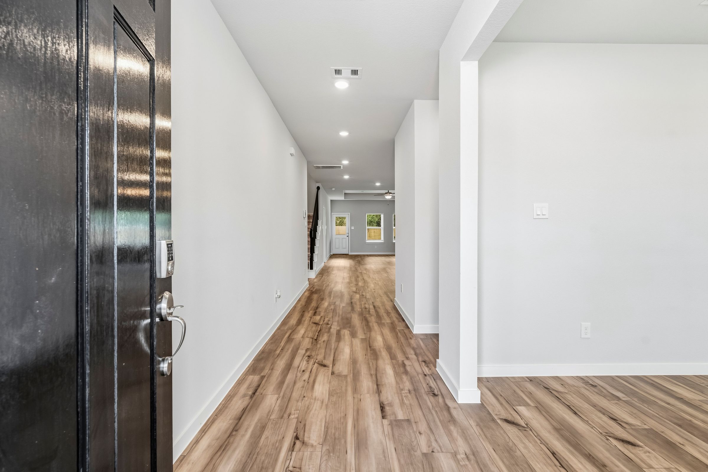 A hallway with white walls.
