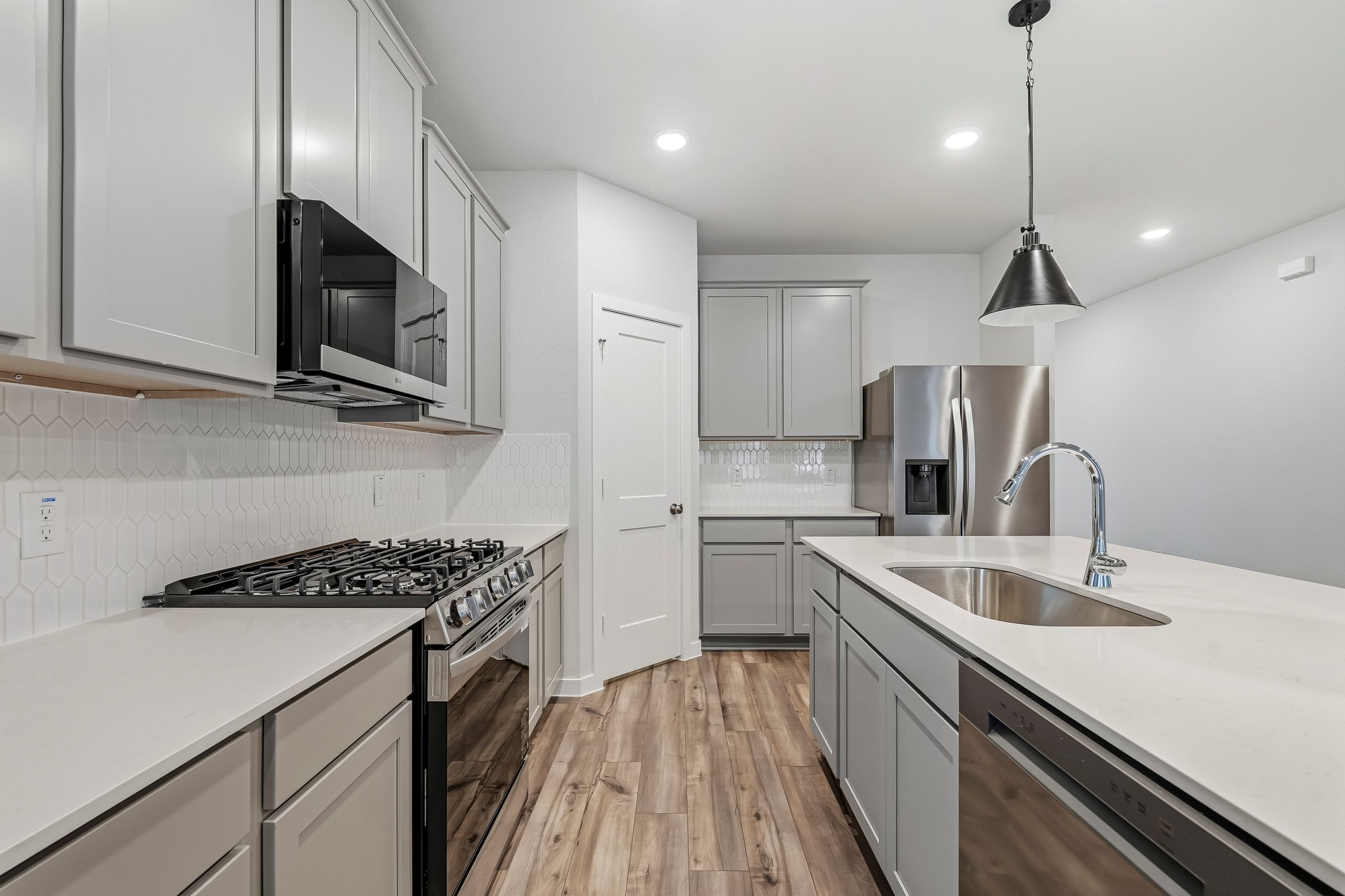 A kitchen with white cabinets.