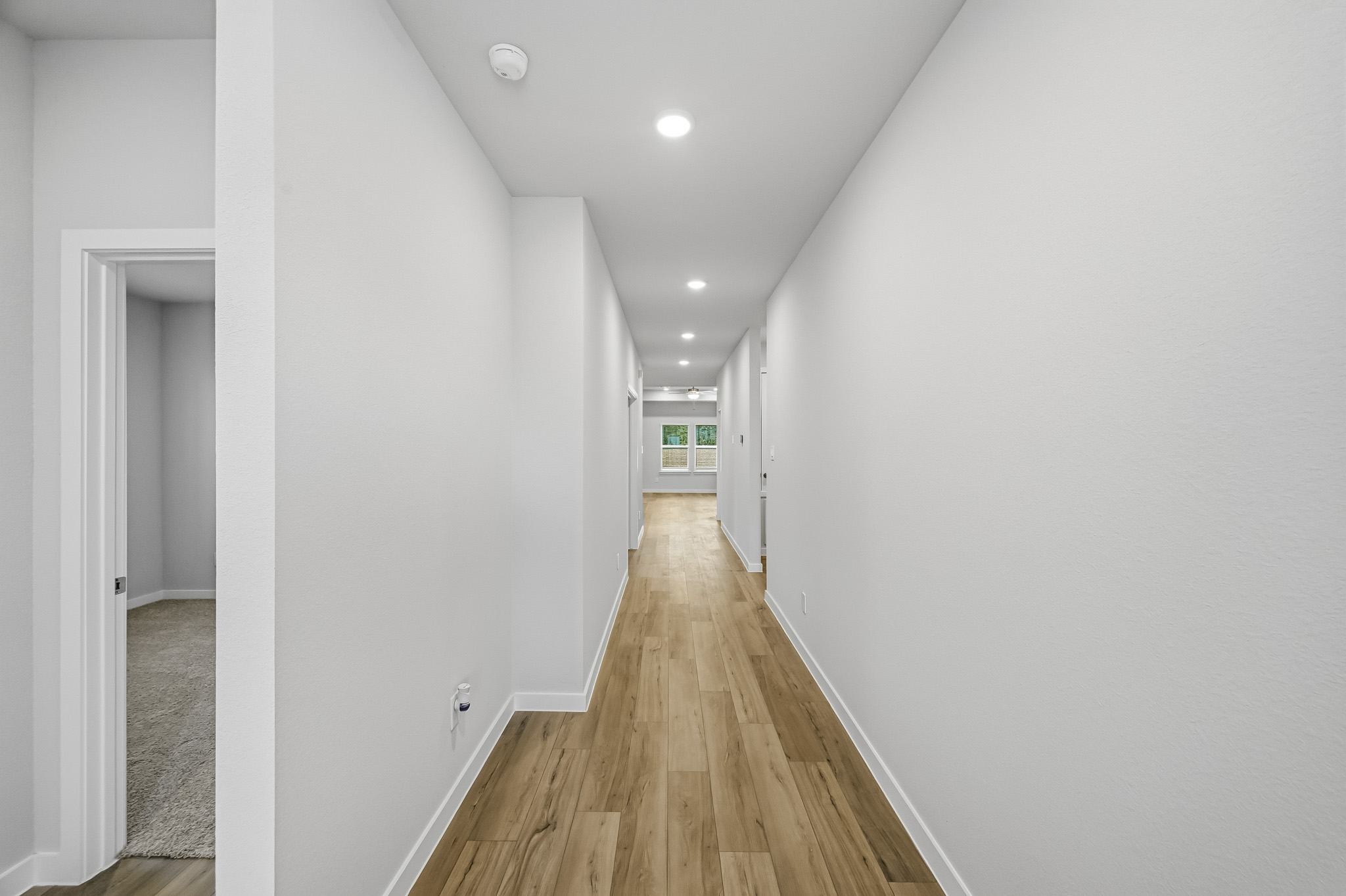 A long hallway with white walls.