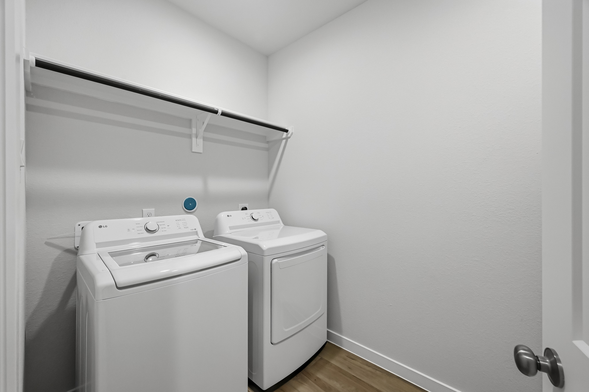 A washing machine and dryer in a room.