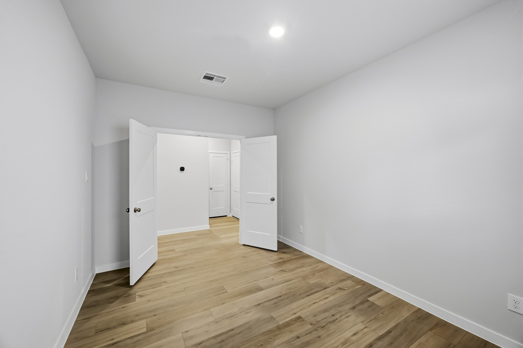 A room with white cabinets.