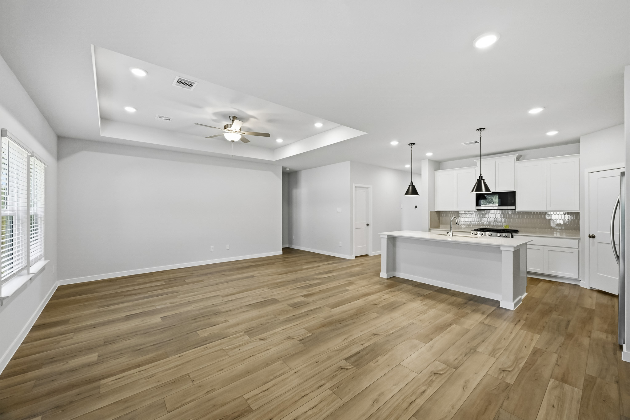 A kitchen with a wood floor.