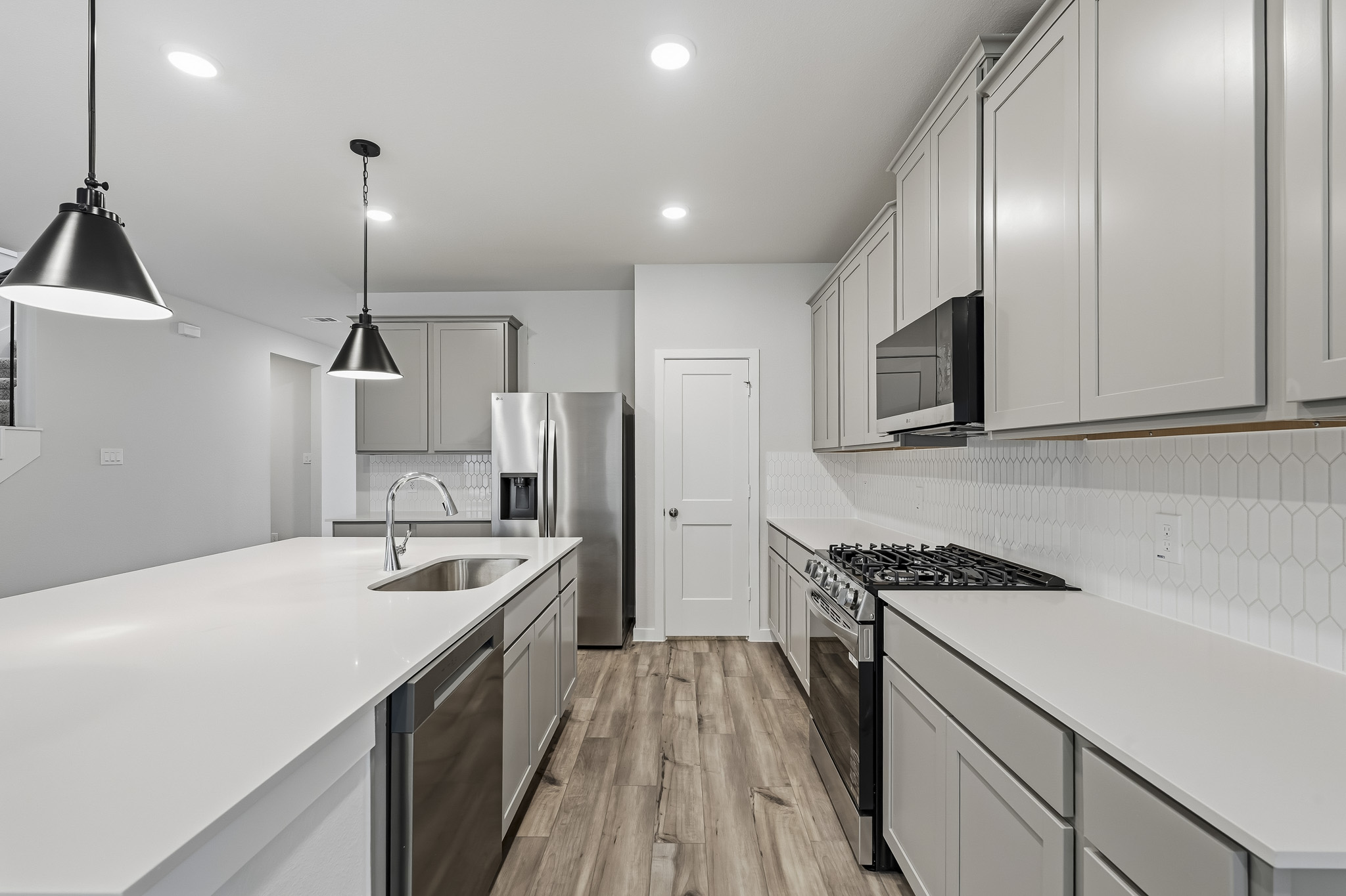 A kitchen with white cabinets.