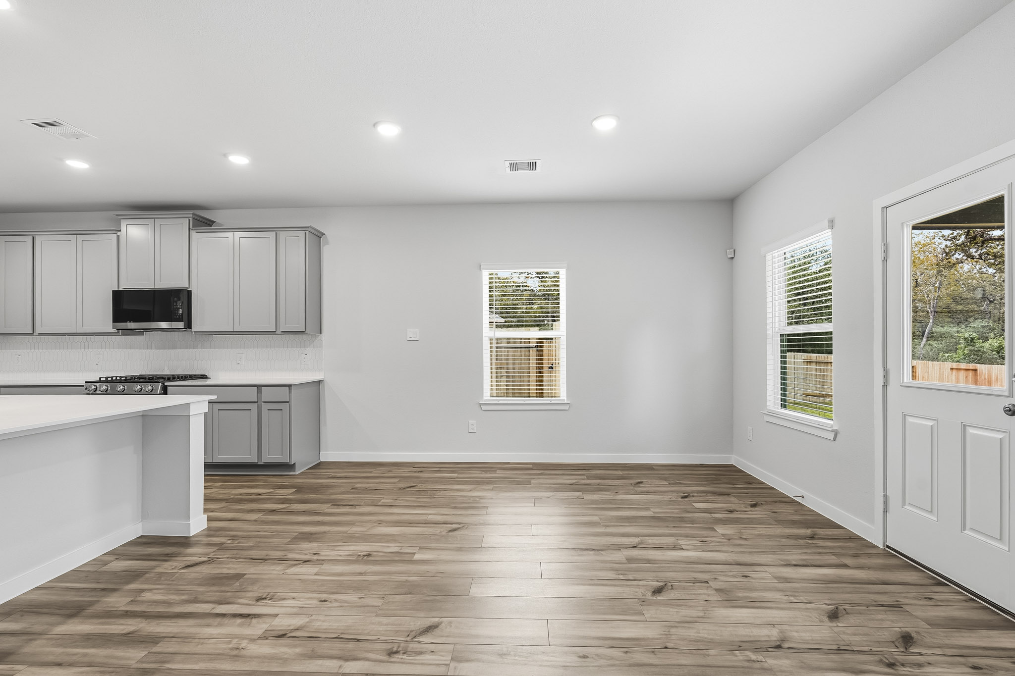 A kitchen with white cabinets.