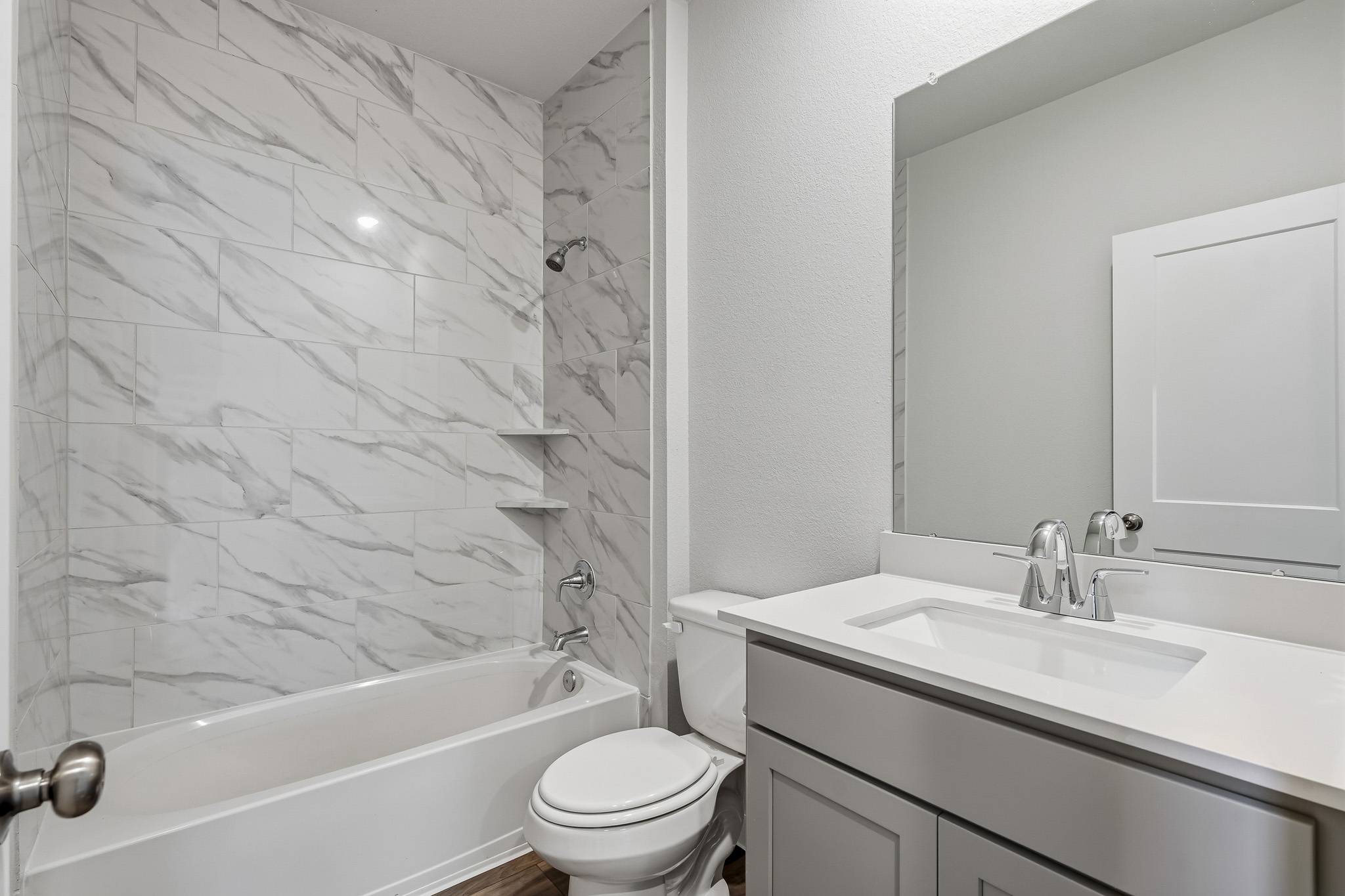 A bathroom with a tub sink and toilet.