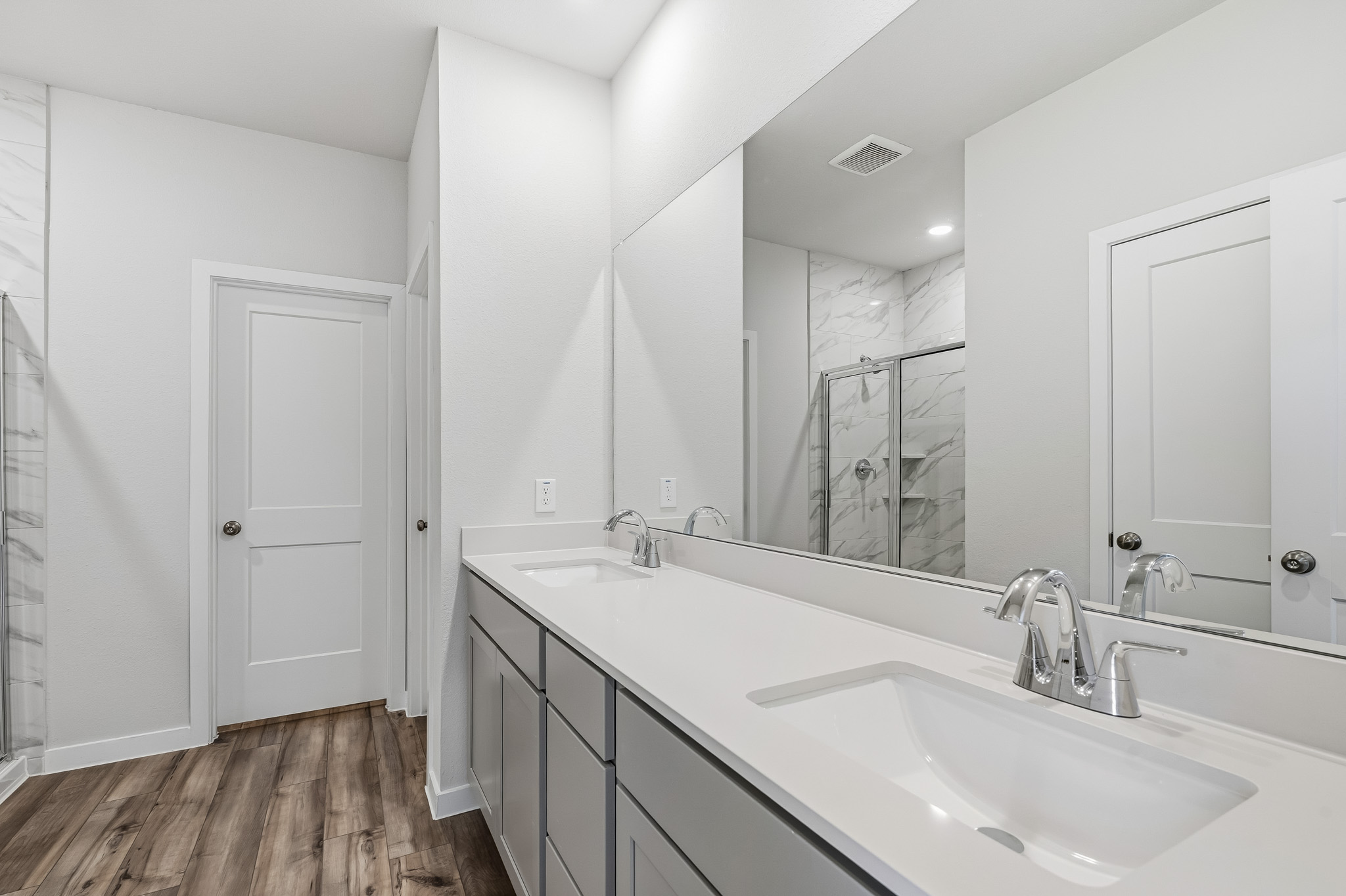 A bathroom with a large mirror.