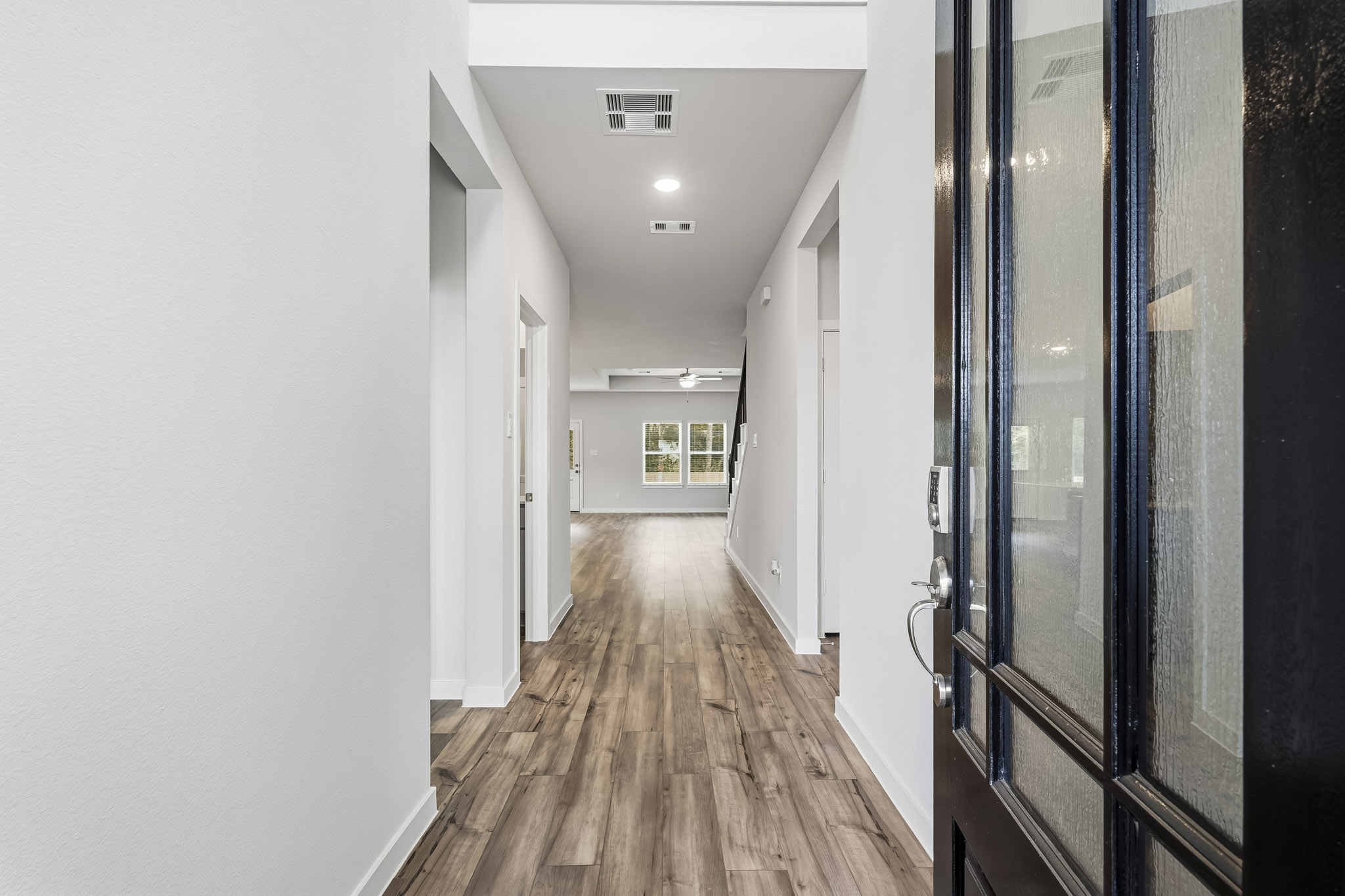 A hallway with glass doors.