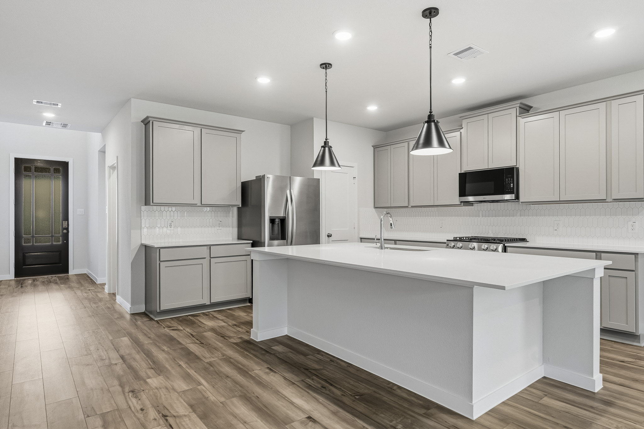 A kitchen with white cabinets.