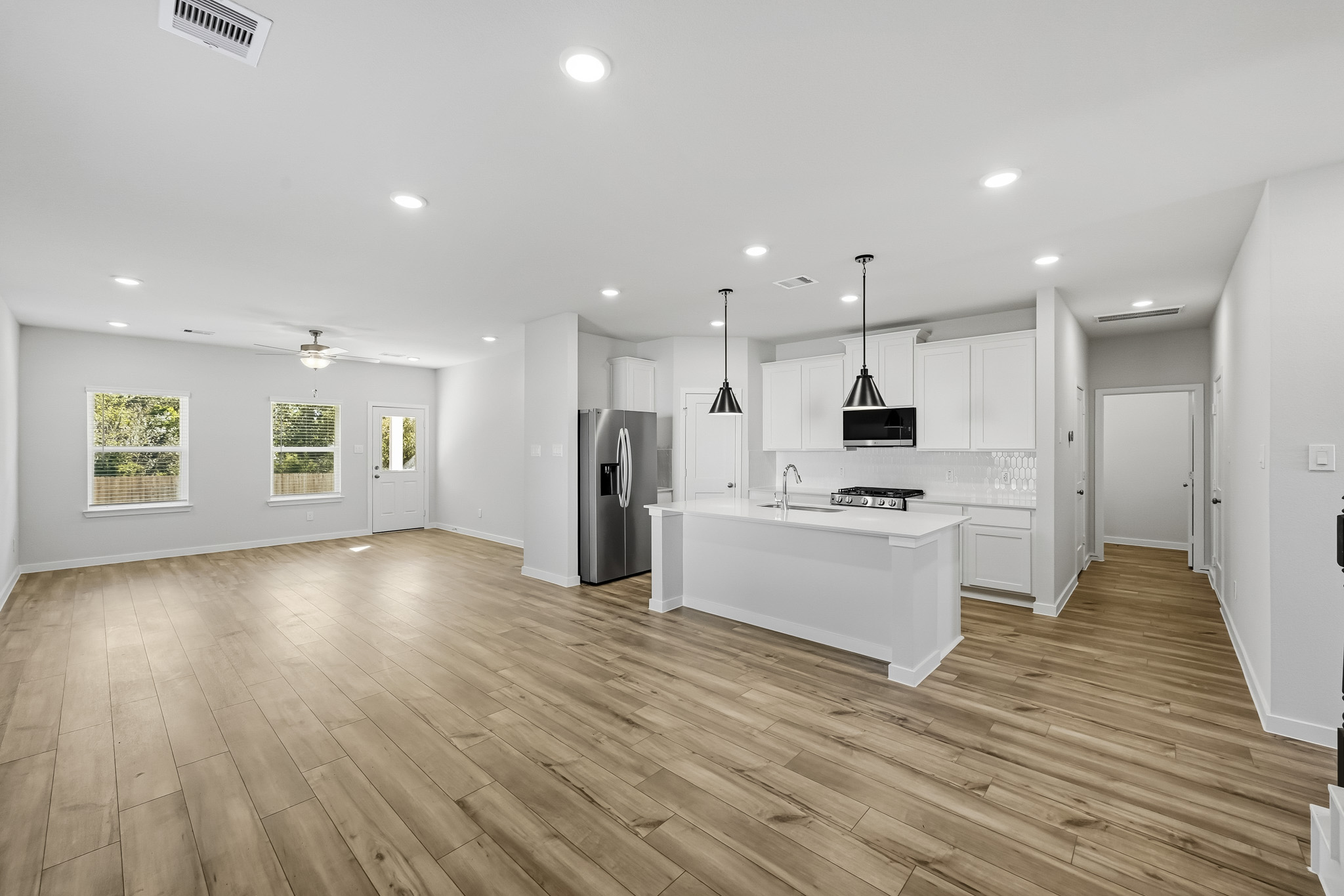 A large kitchen with white cabinets.