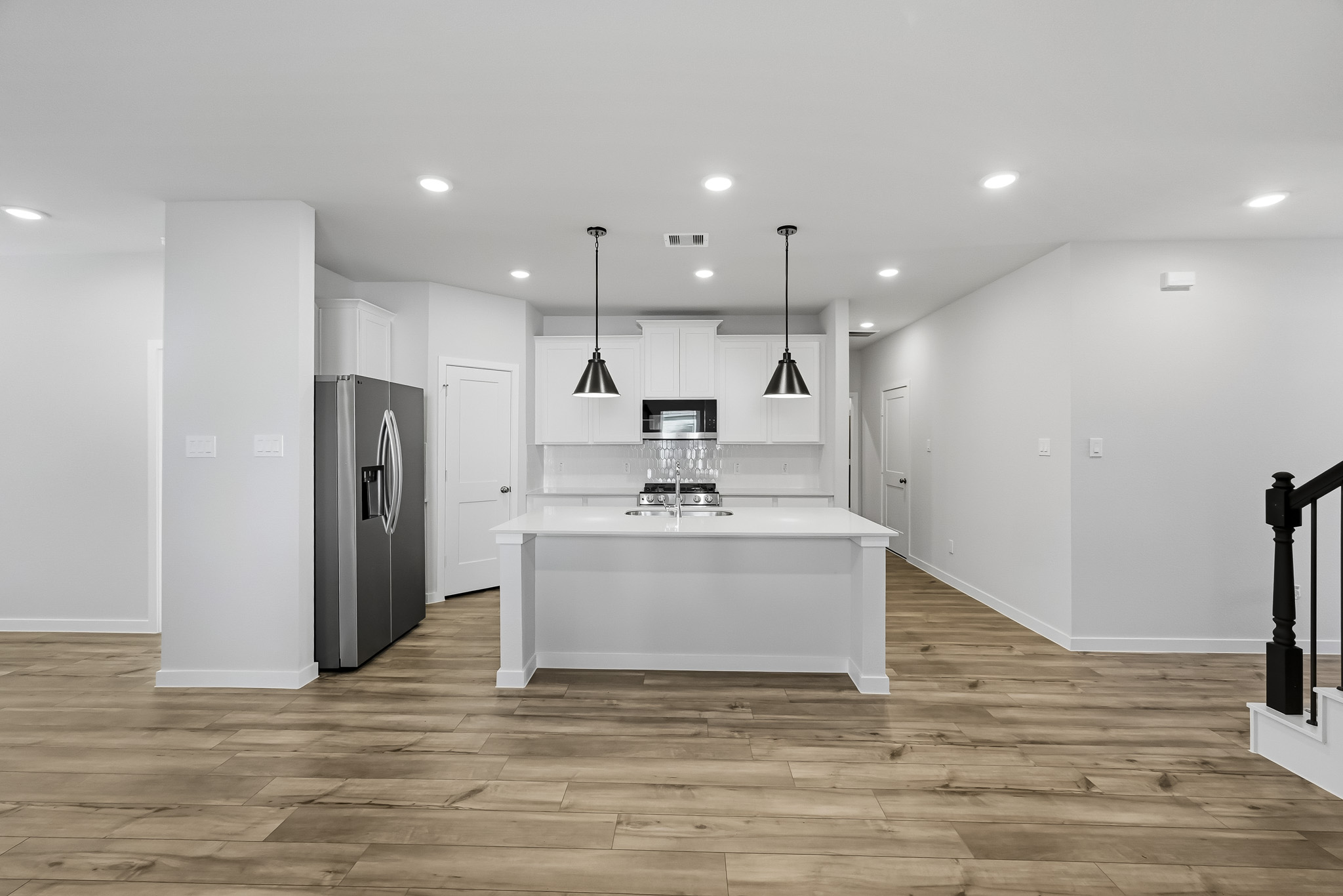 A large kitchen with white cabinets.