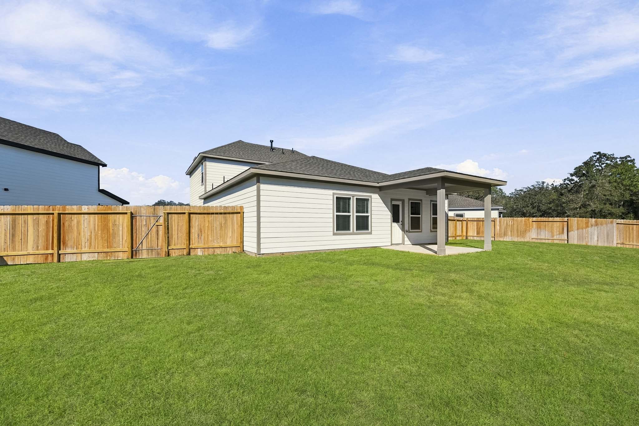A house with a fence and grass.