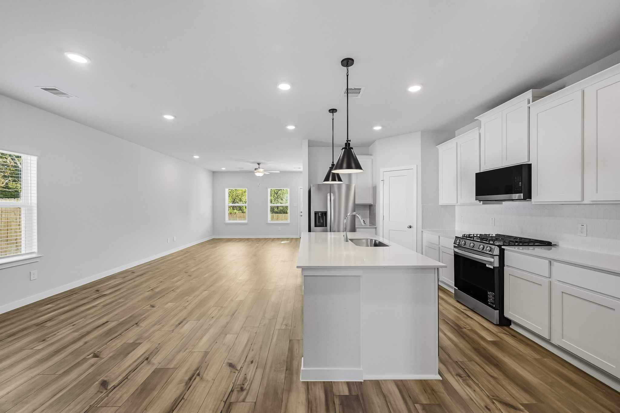 A kitchen with white cabinets.