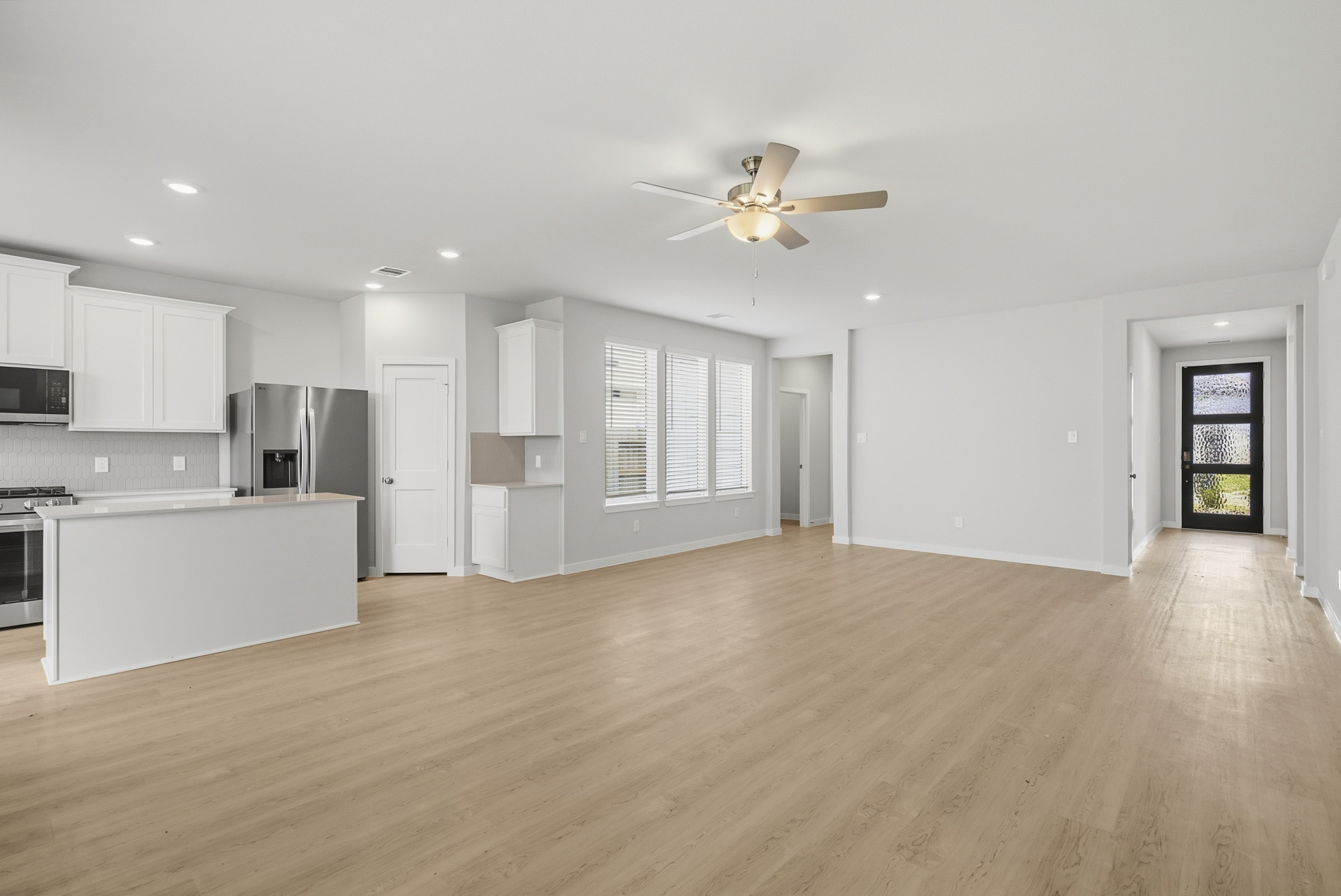 A large kitchen with white cabinets.