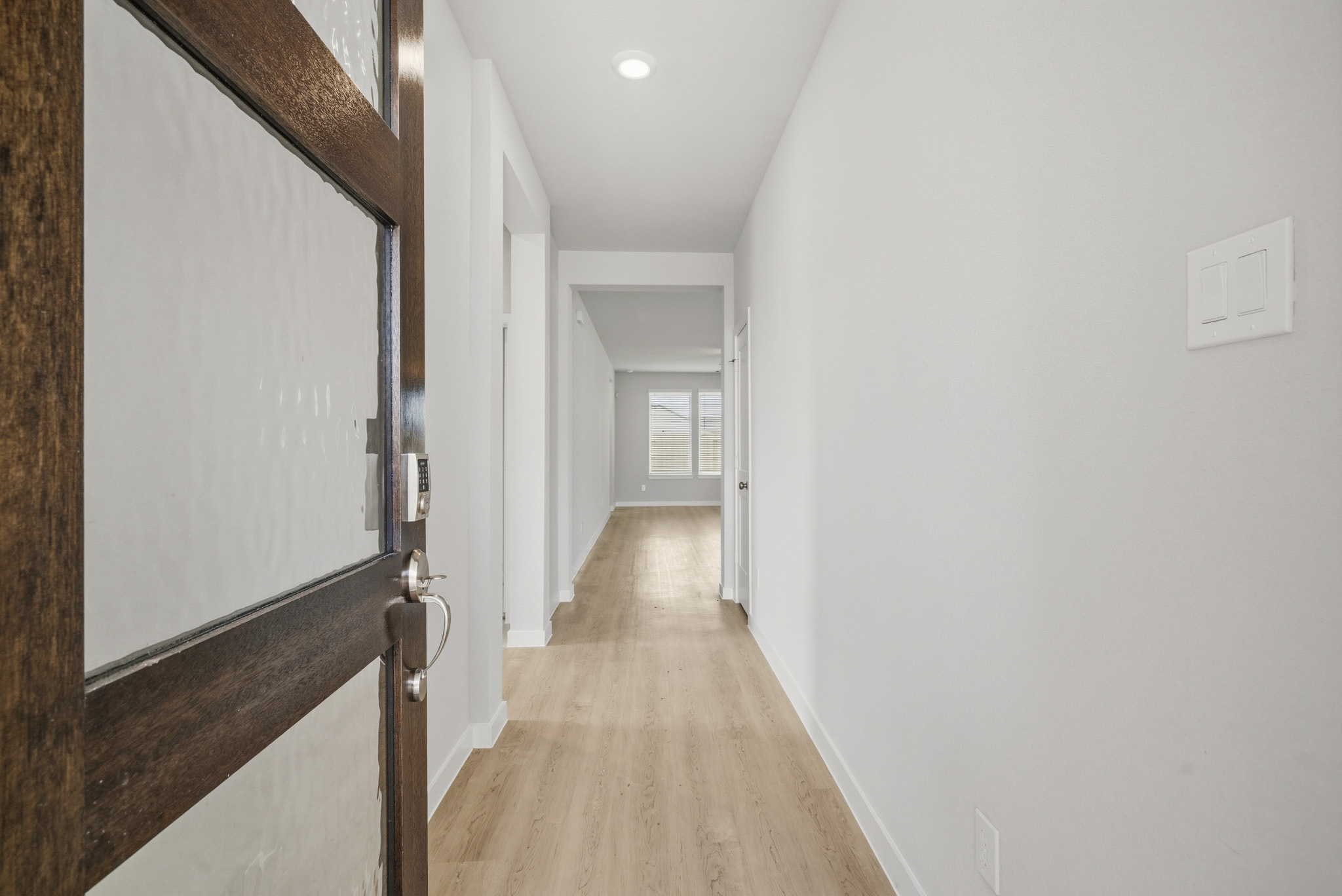 A hallway with white walls.