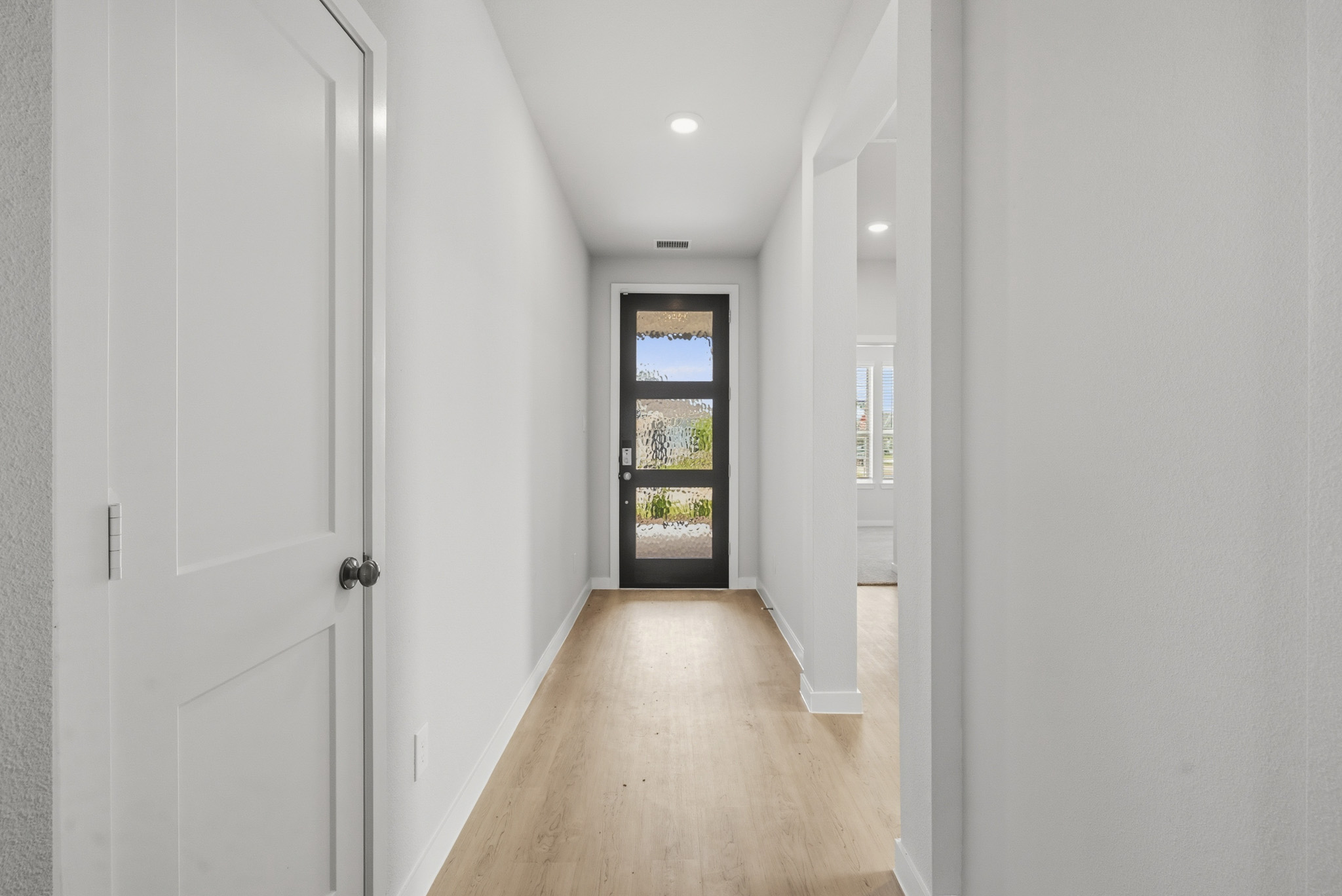 A hallway with white doors.