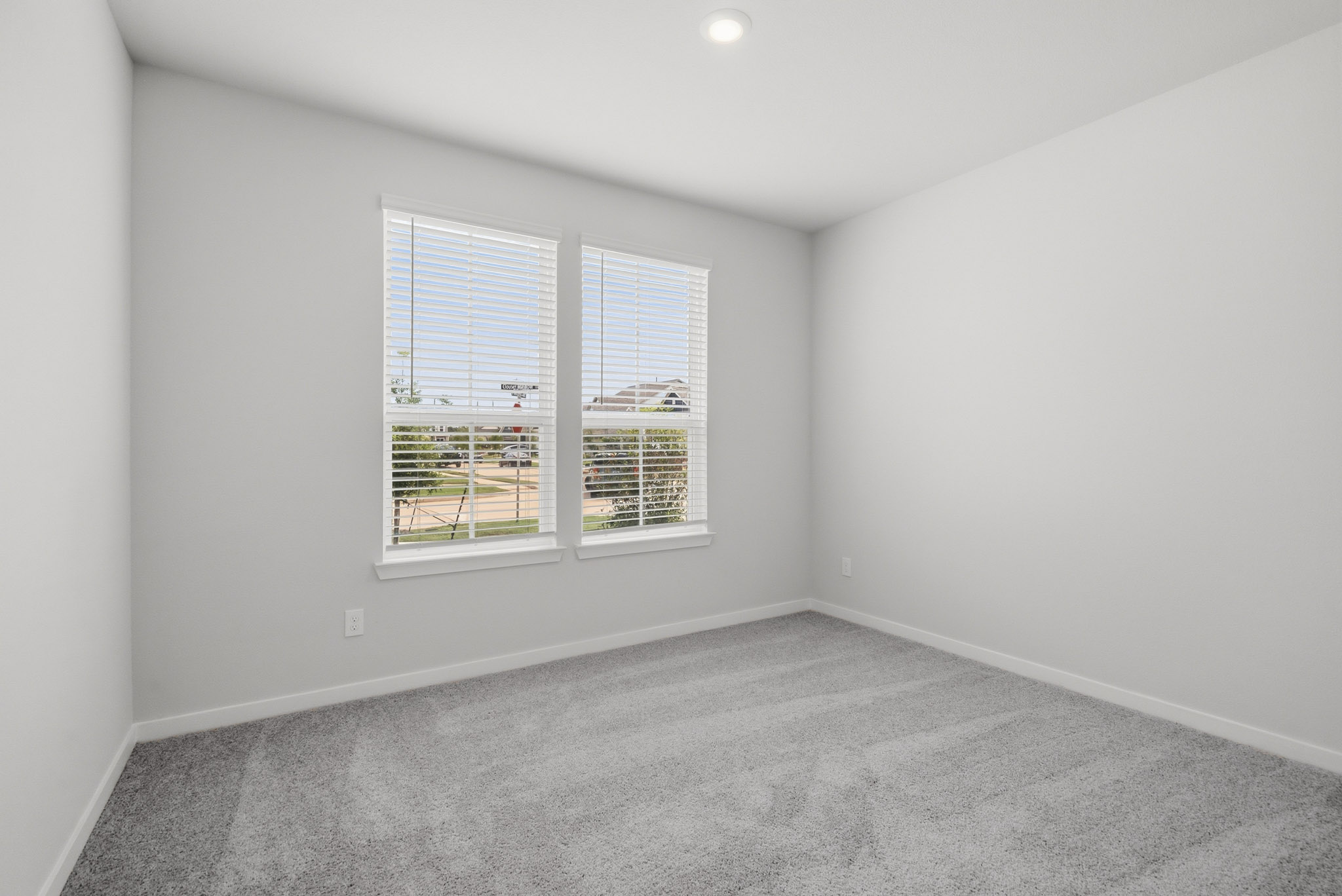 A room with a window and a carpet.