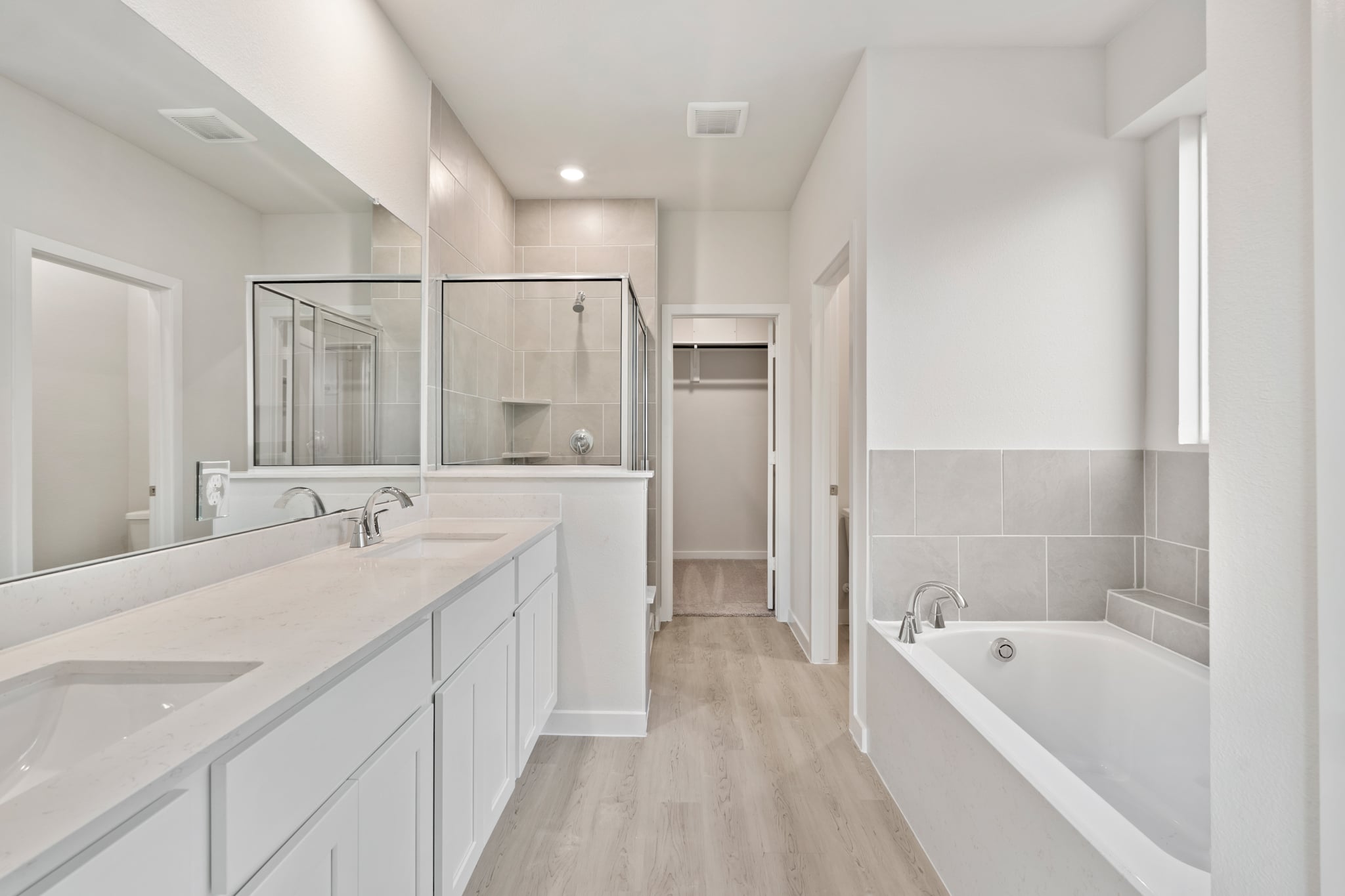 A bathroom with a tub sink and a bathtub.