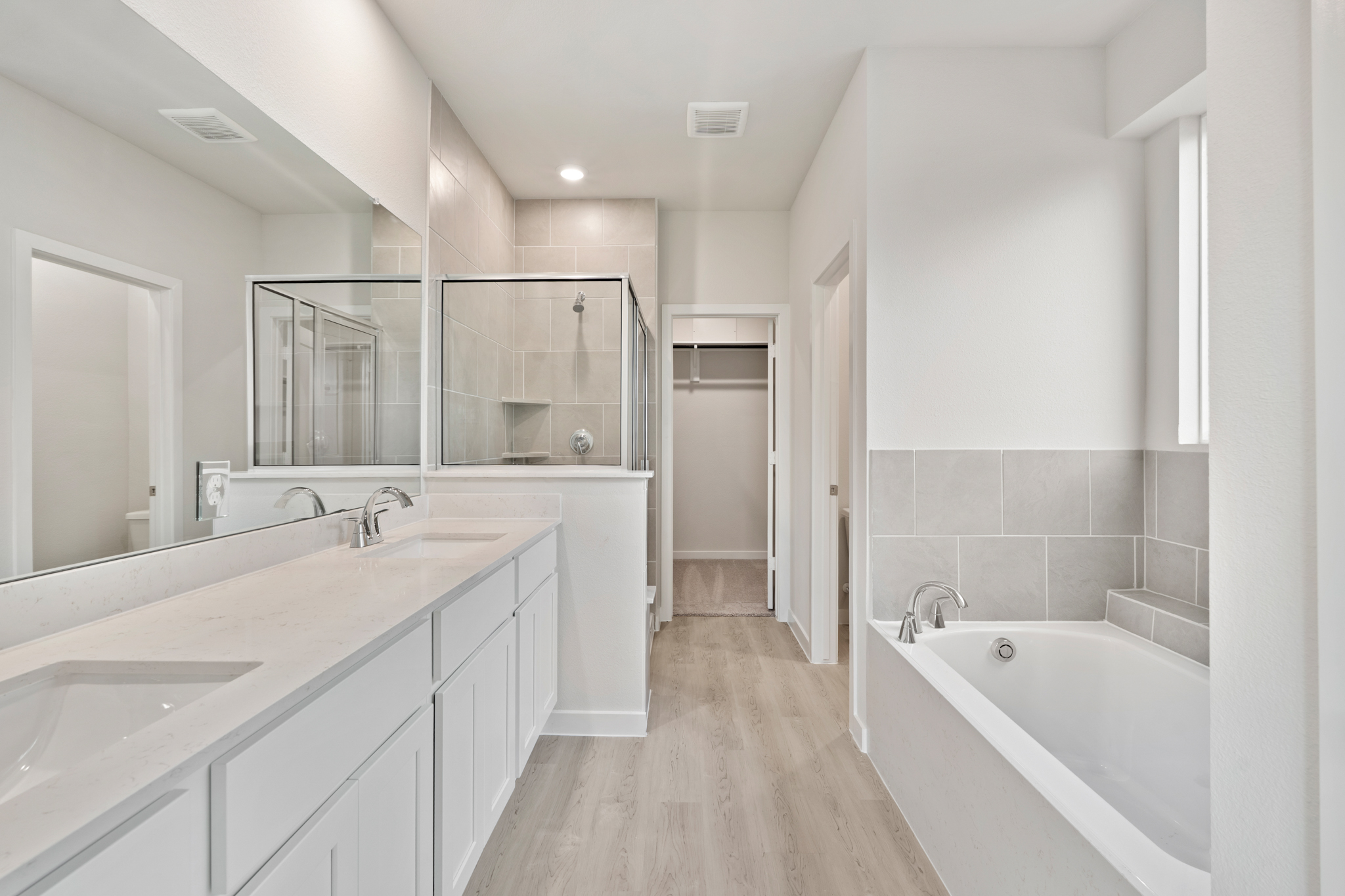 A bathroom with a tub sink and a bathtub.