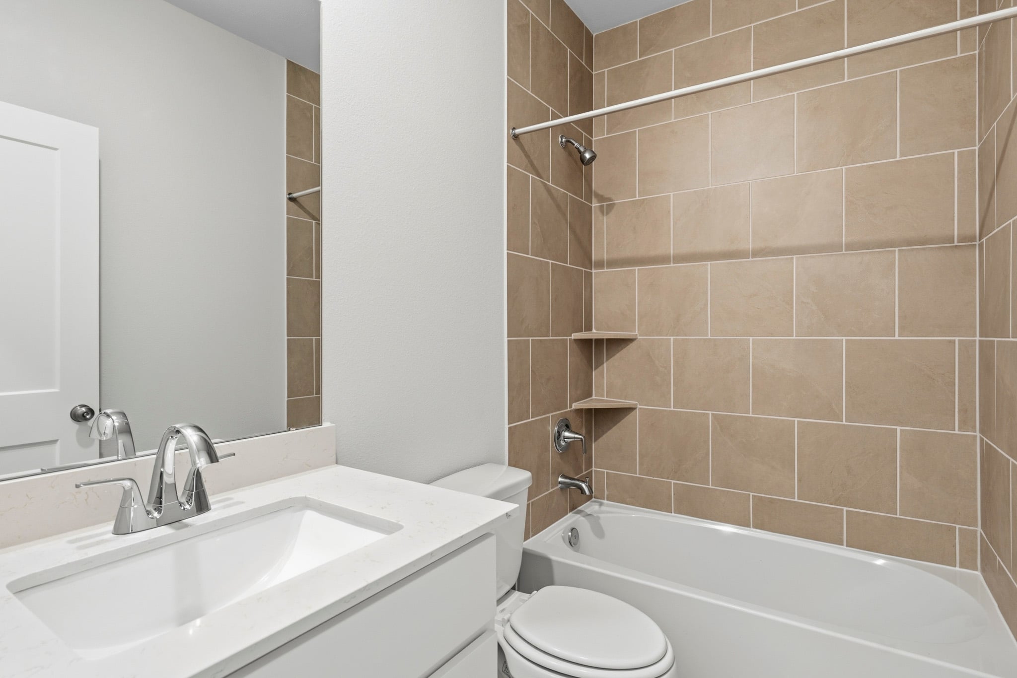 A bathroom with a sink toilet and bathtub.
