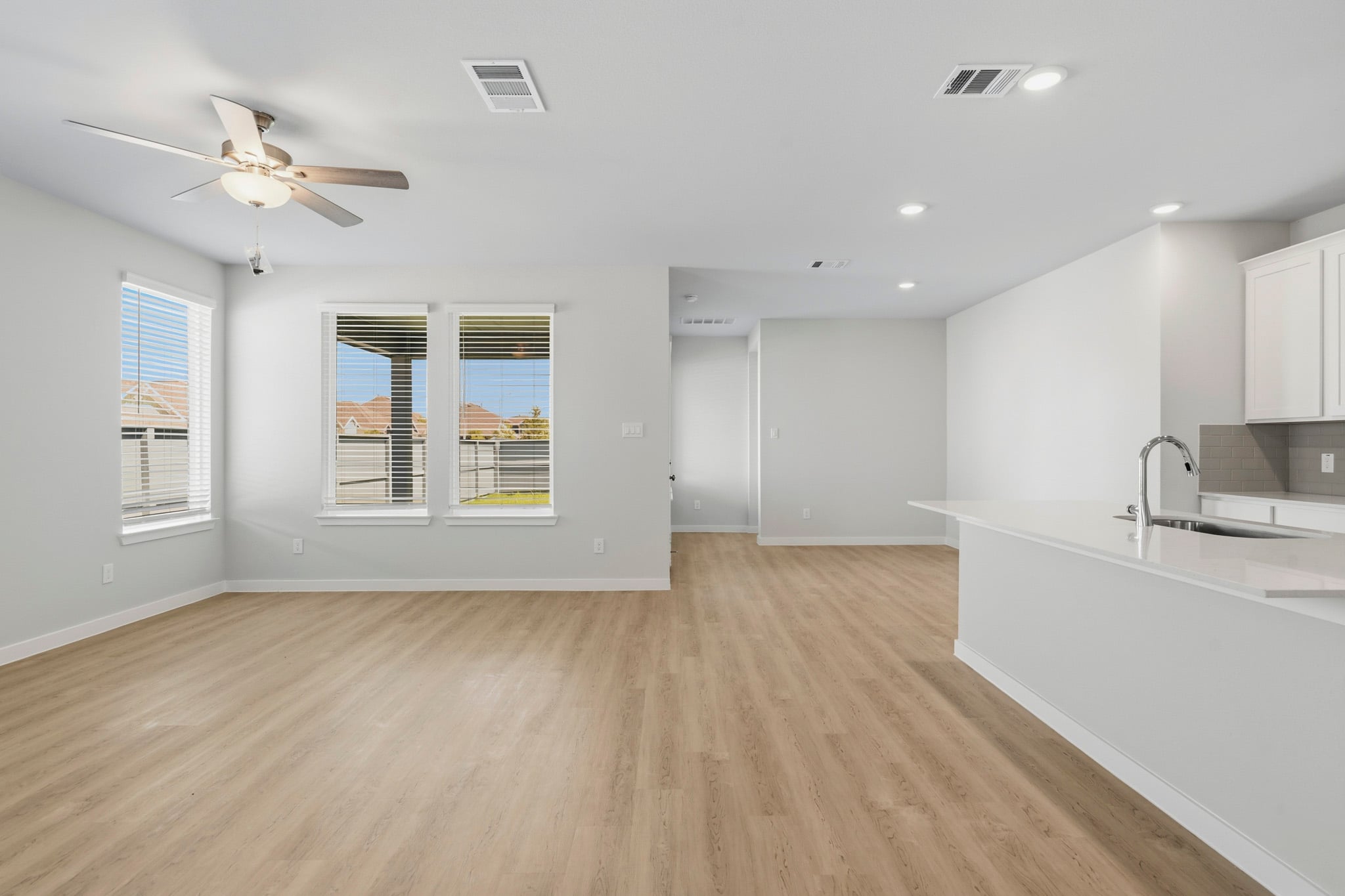 A kitchen with white cabinets.