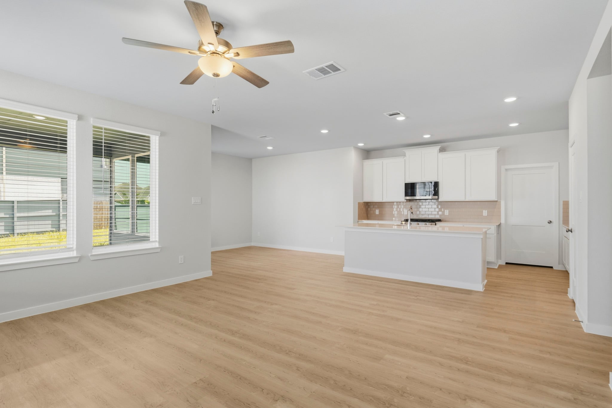 A large kitchen with white cabinets.