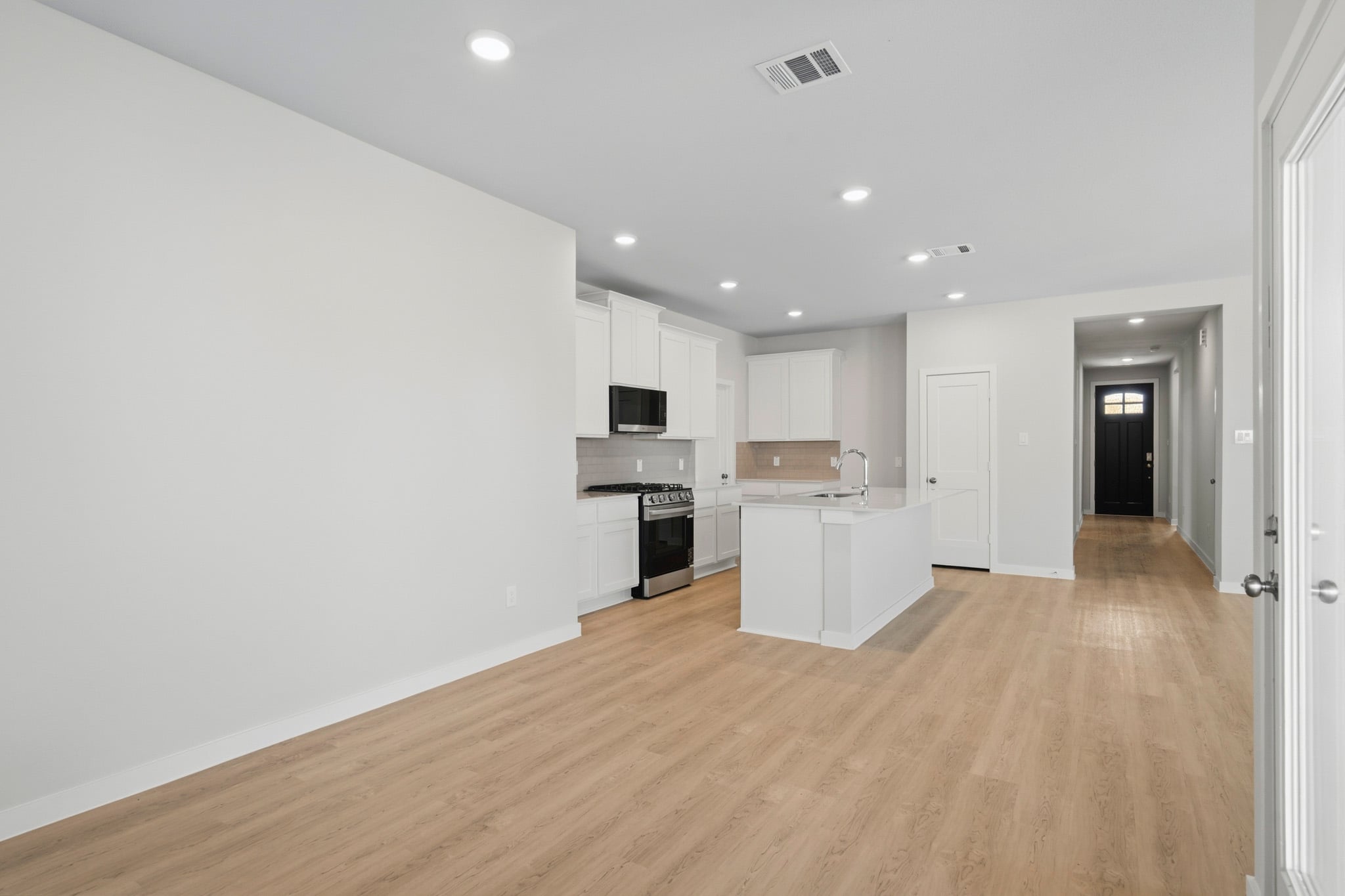 A kitchen with white cabinets.
