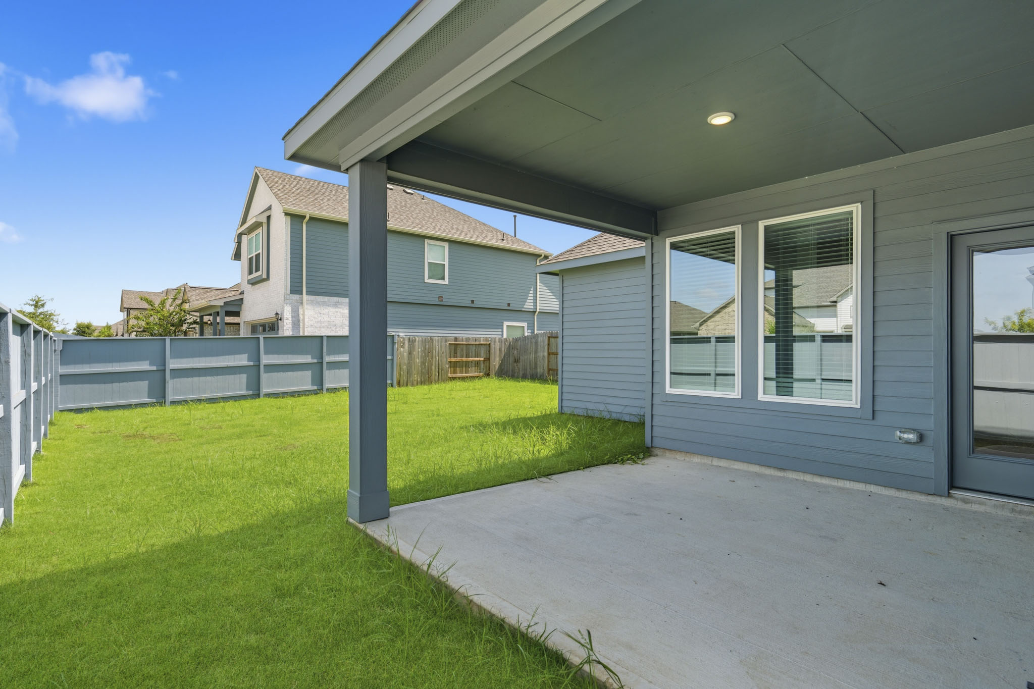 A house with a fence and grass.