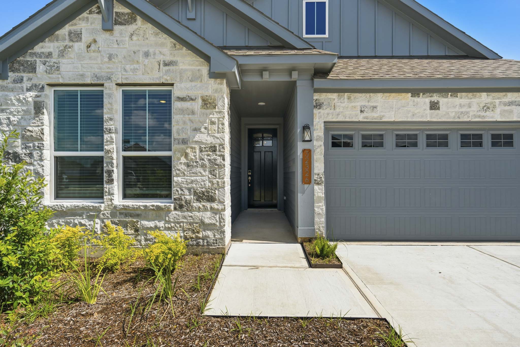 A building with a garage and a door.