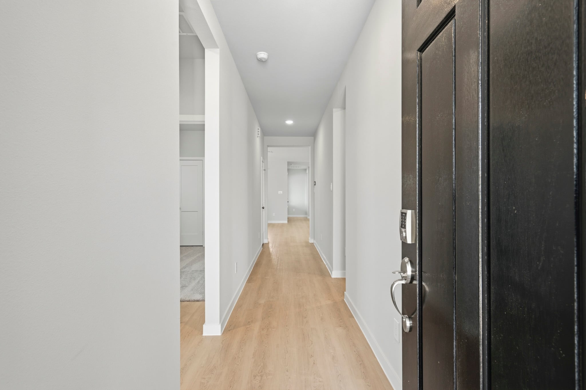 A hallway with black doors.