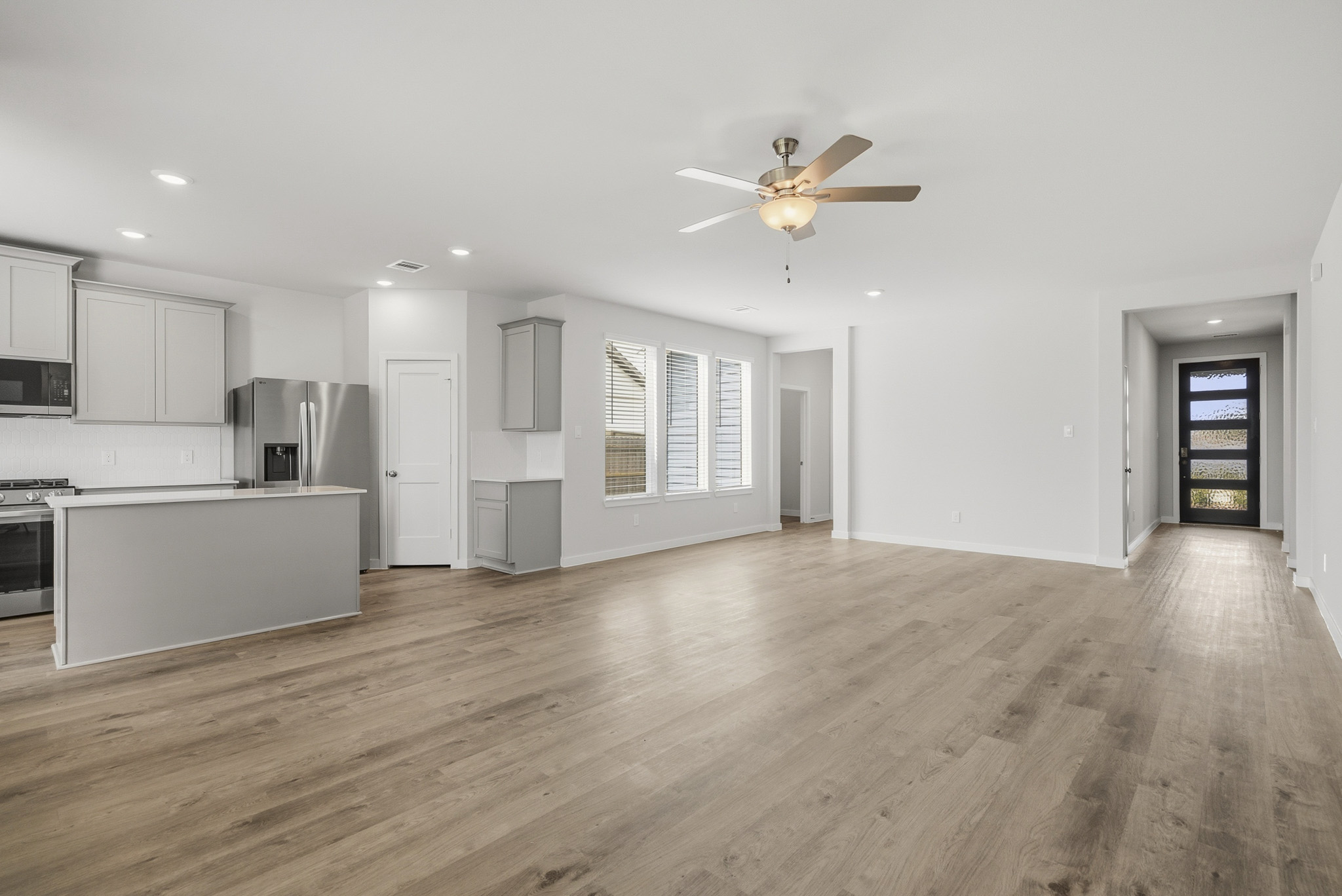 A large kitchen with white cabinets.