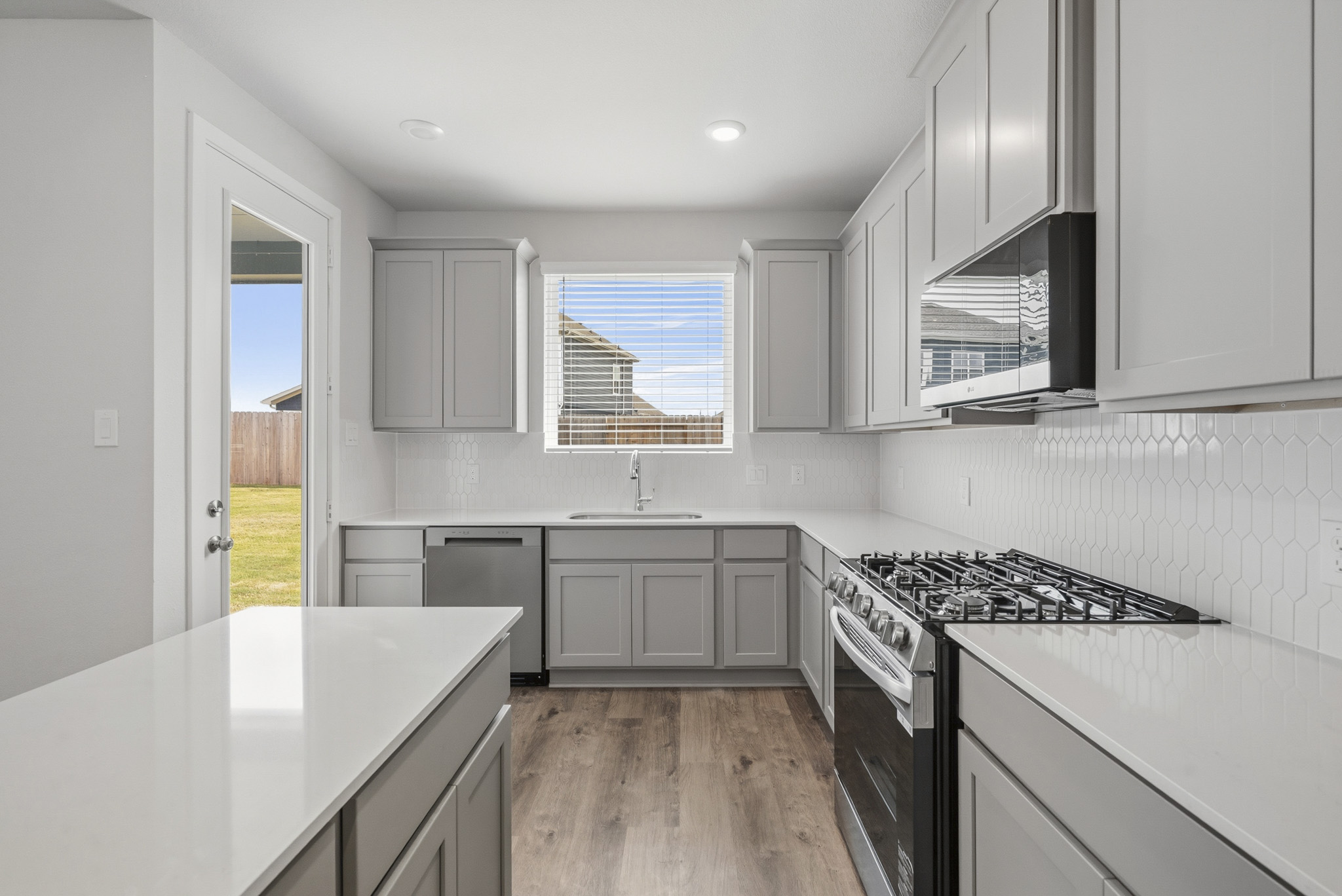 A kitchen with white cabinets.