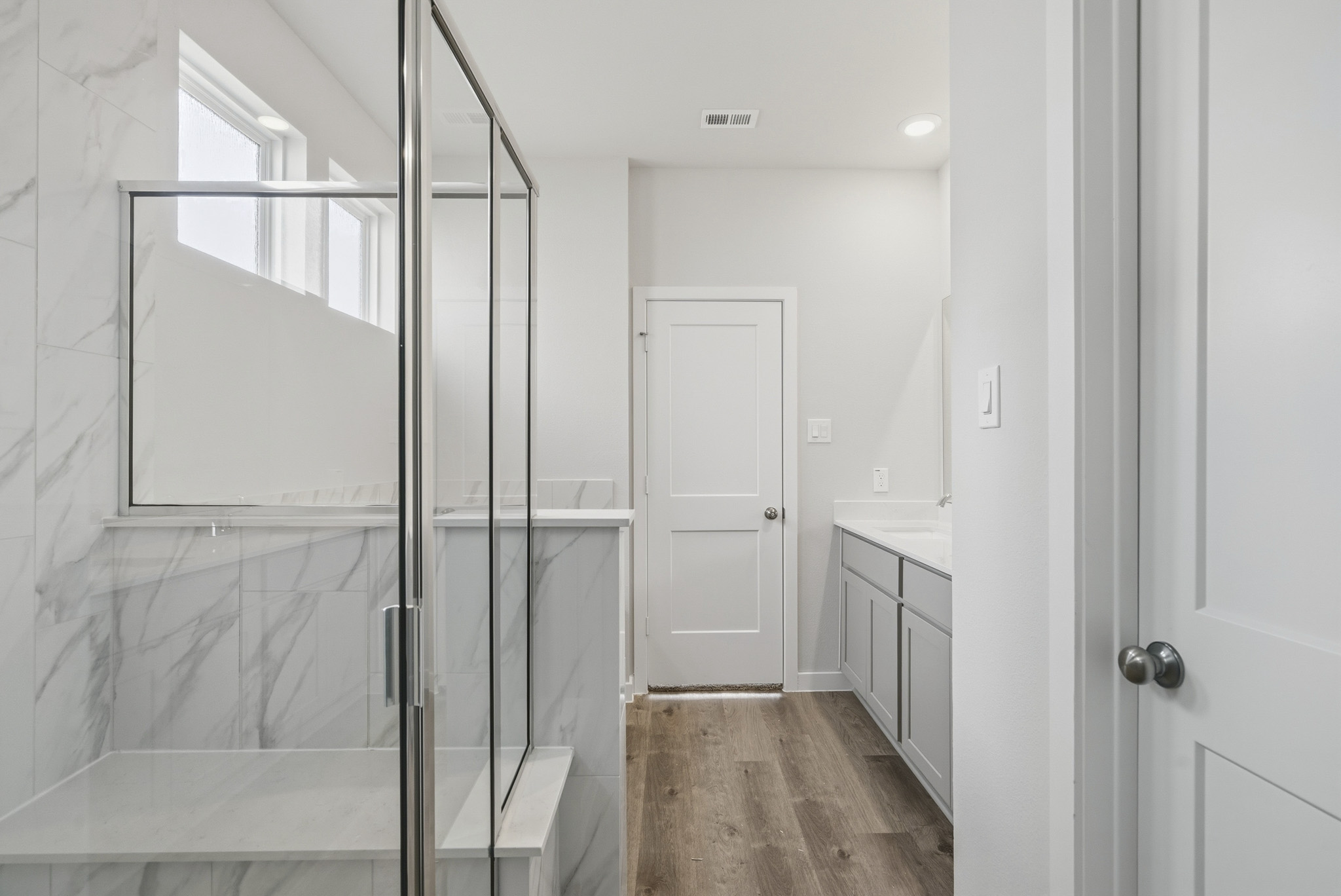 A bathroom with a glass shower.