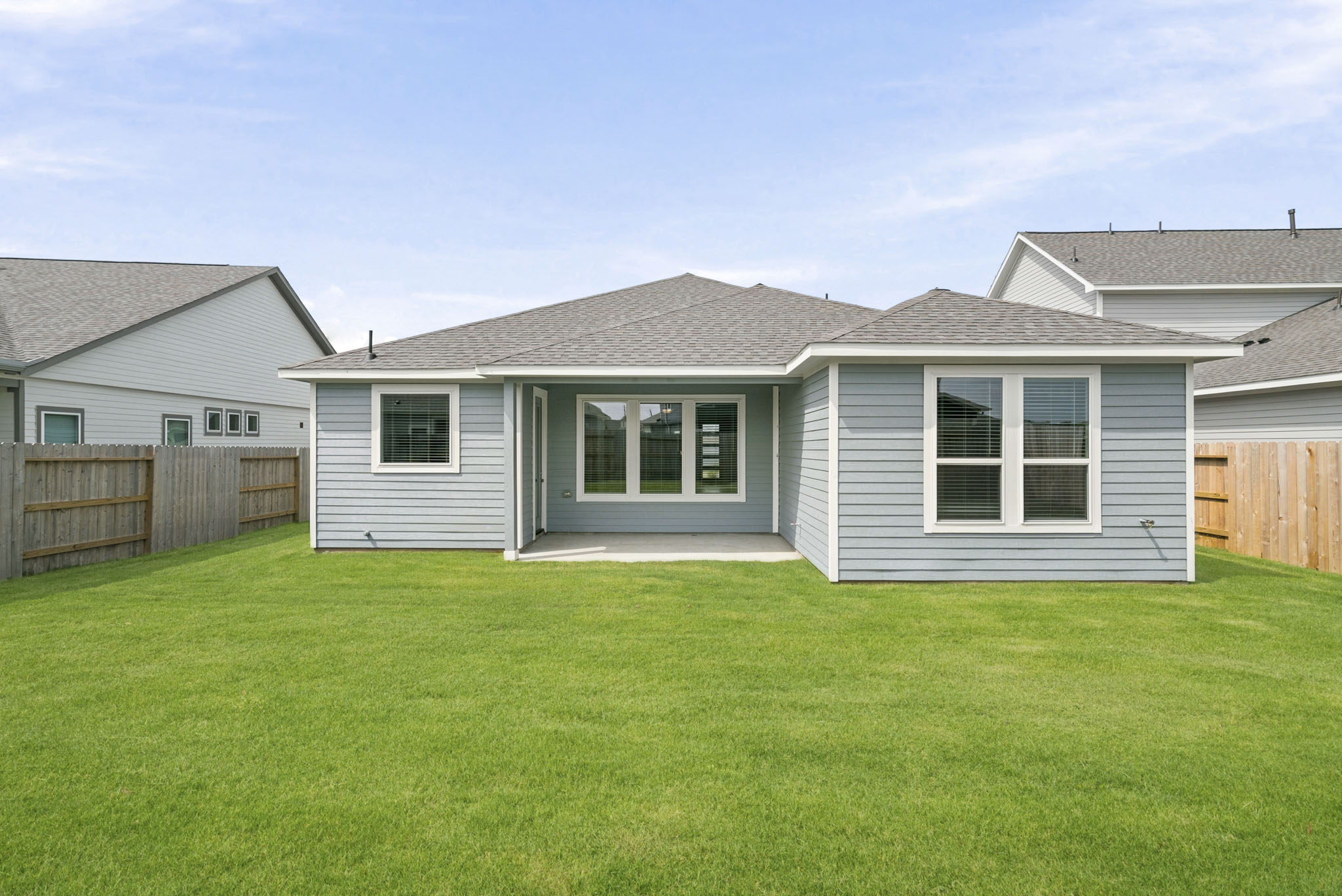 A house with a fence and grass.