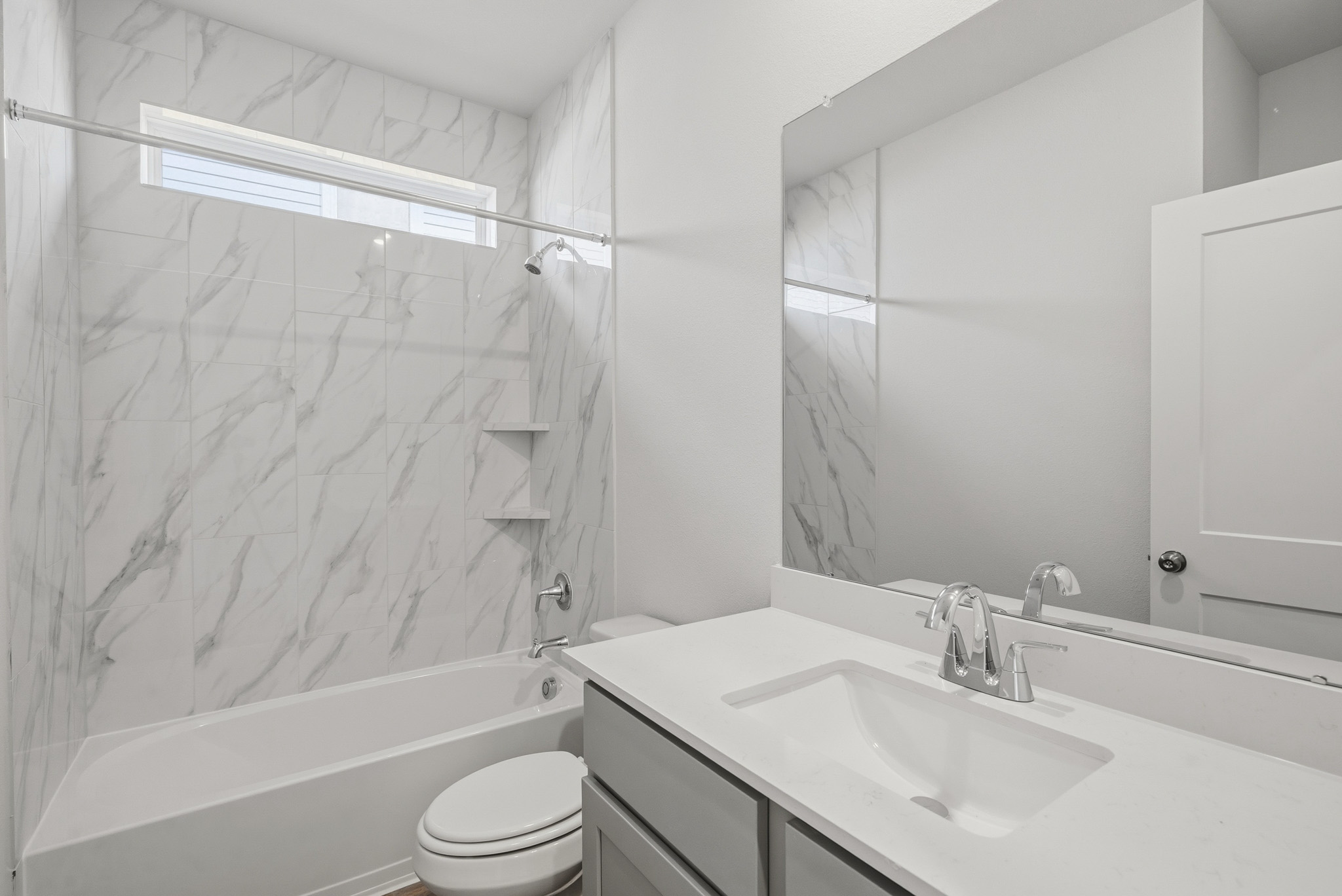 A bathroom with a shower and sink.