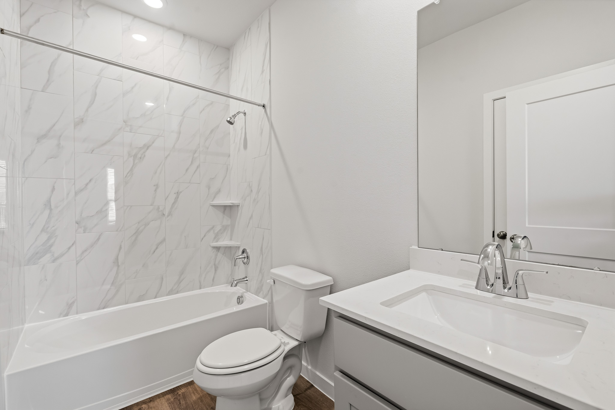 A bathroom with a tub sink and toilet.