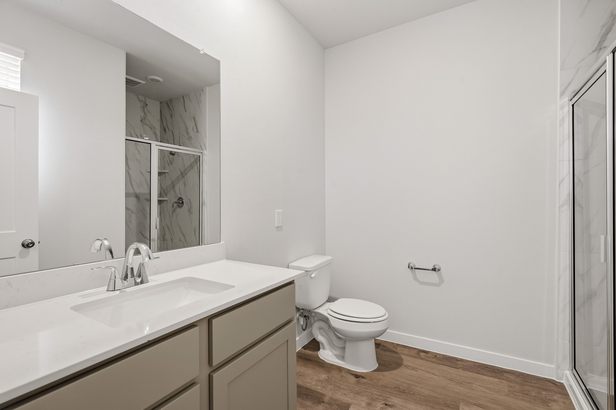 A bathroom with a toilet and sink.