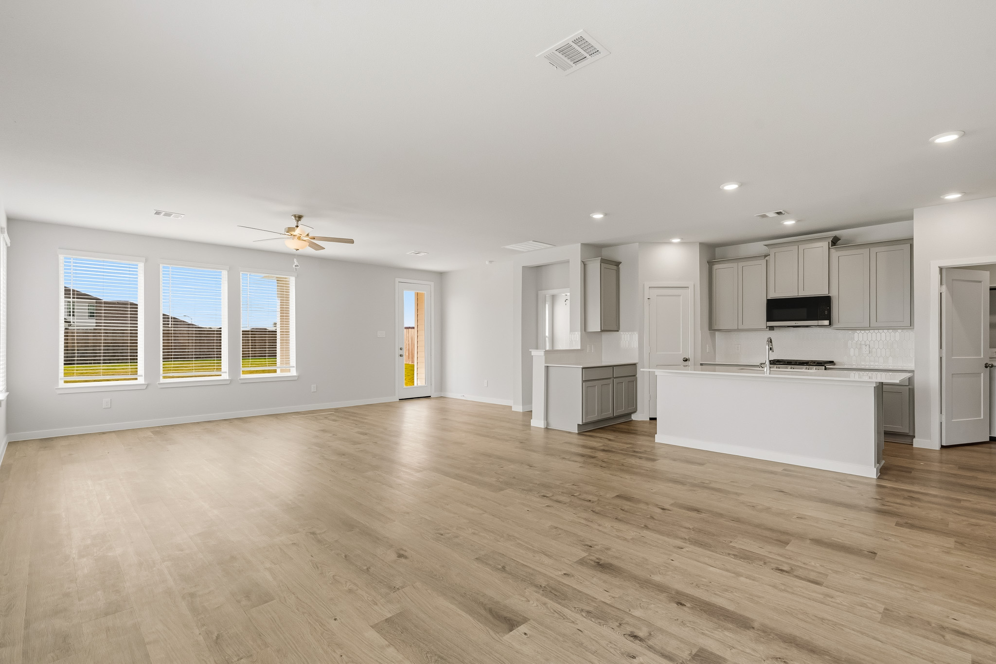 A large kitchen with white cabinets.